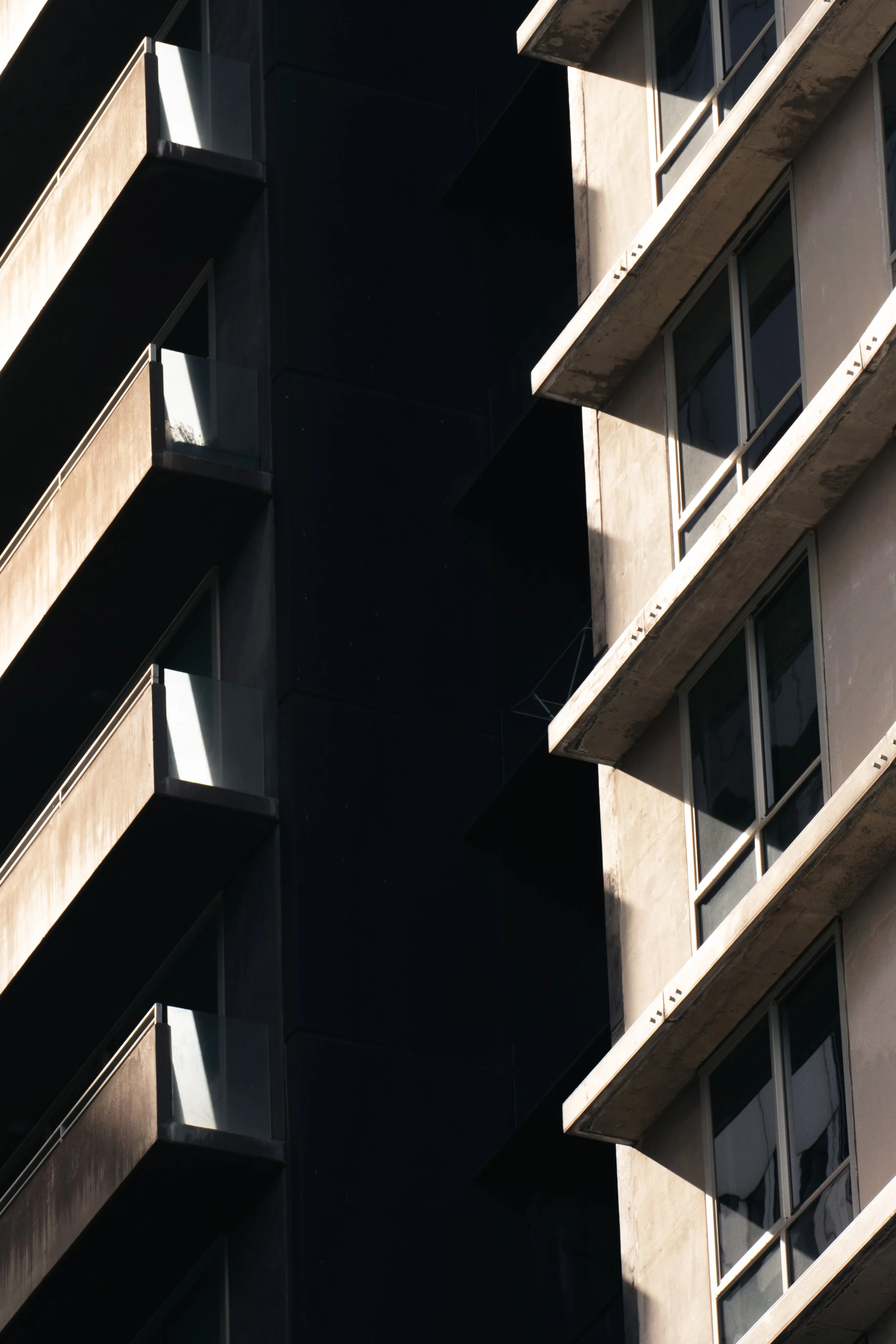 contrasting darkness and light between two buildings