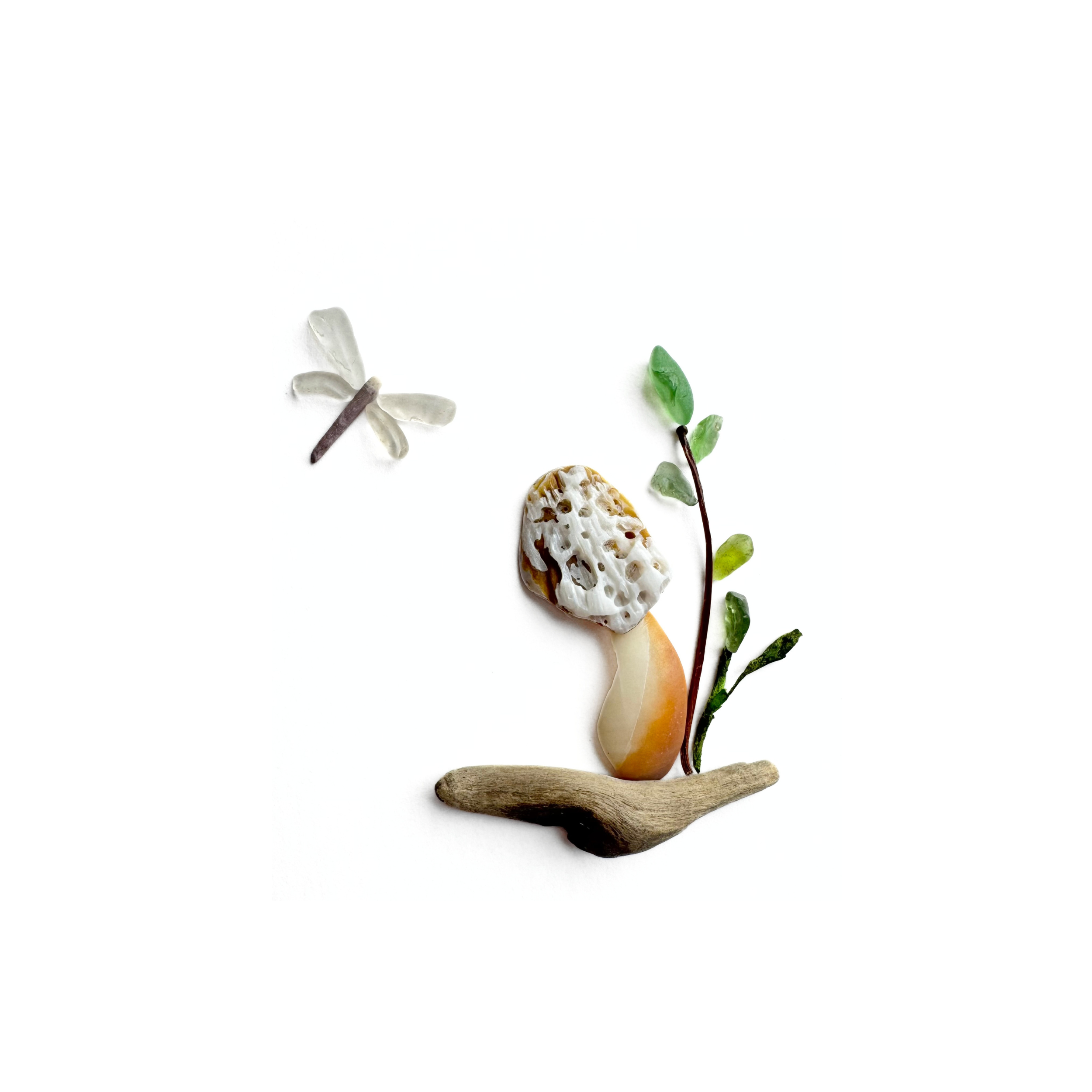 A morel mushroom and delicate dragonfly created with sea glass, beachcombed treasures, and preserved botanical elements.