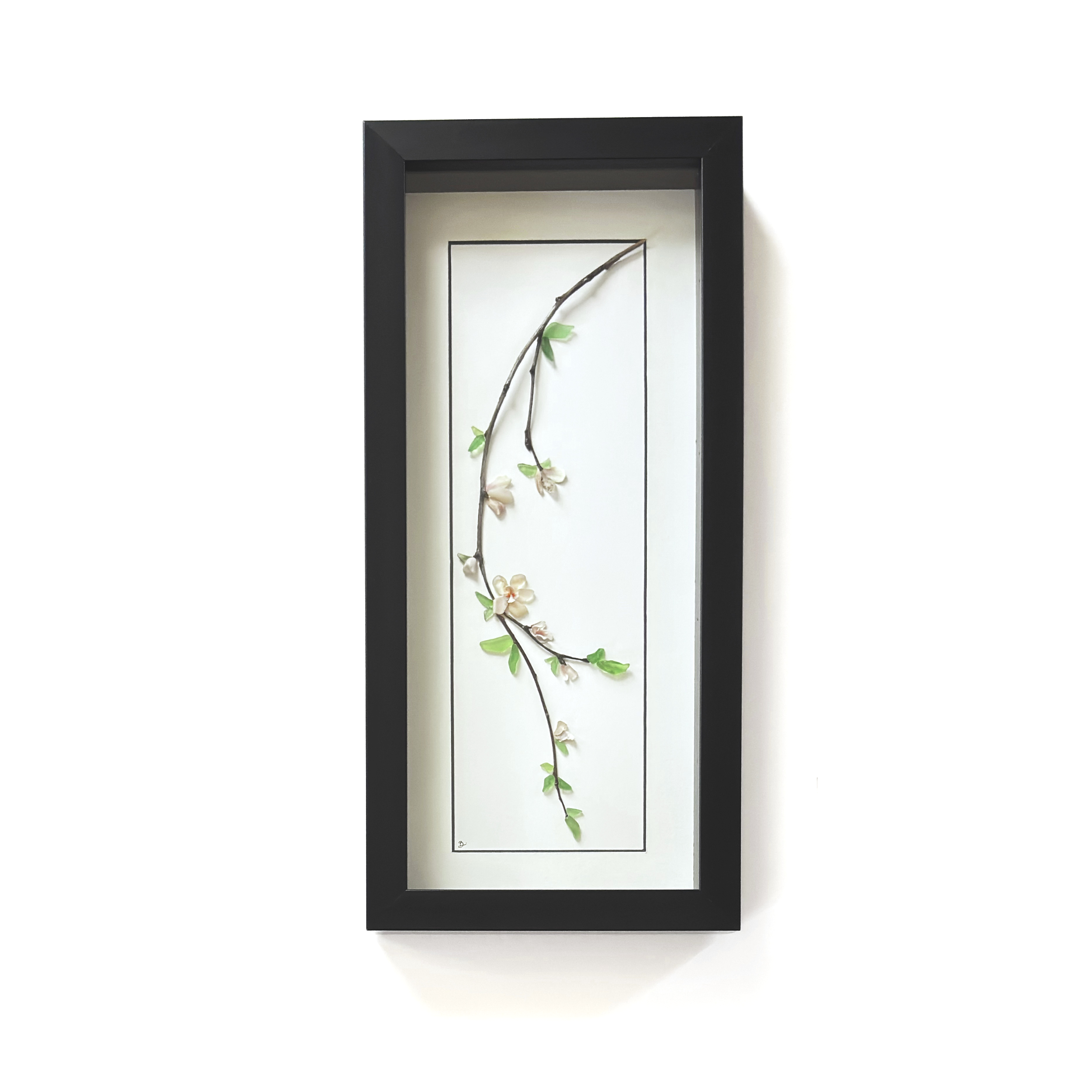 Tall cherry blossom branch created with sea glass, shells, and natural twigs, displayed in a black shadowbox frame.