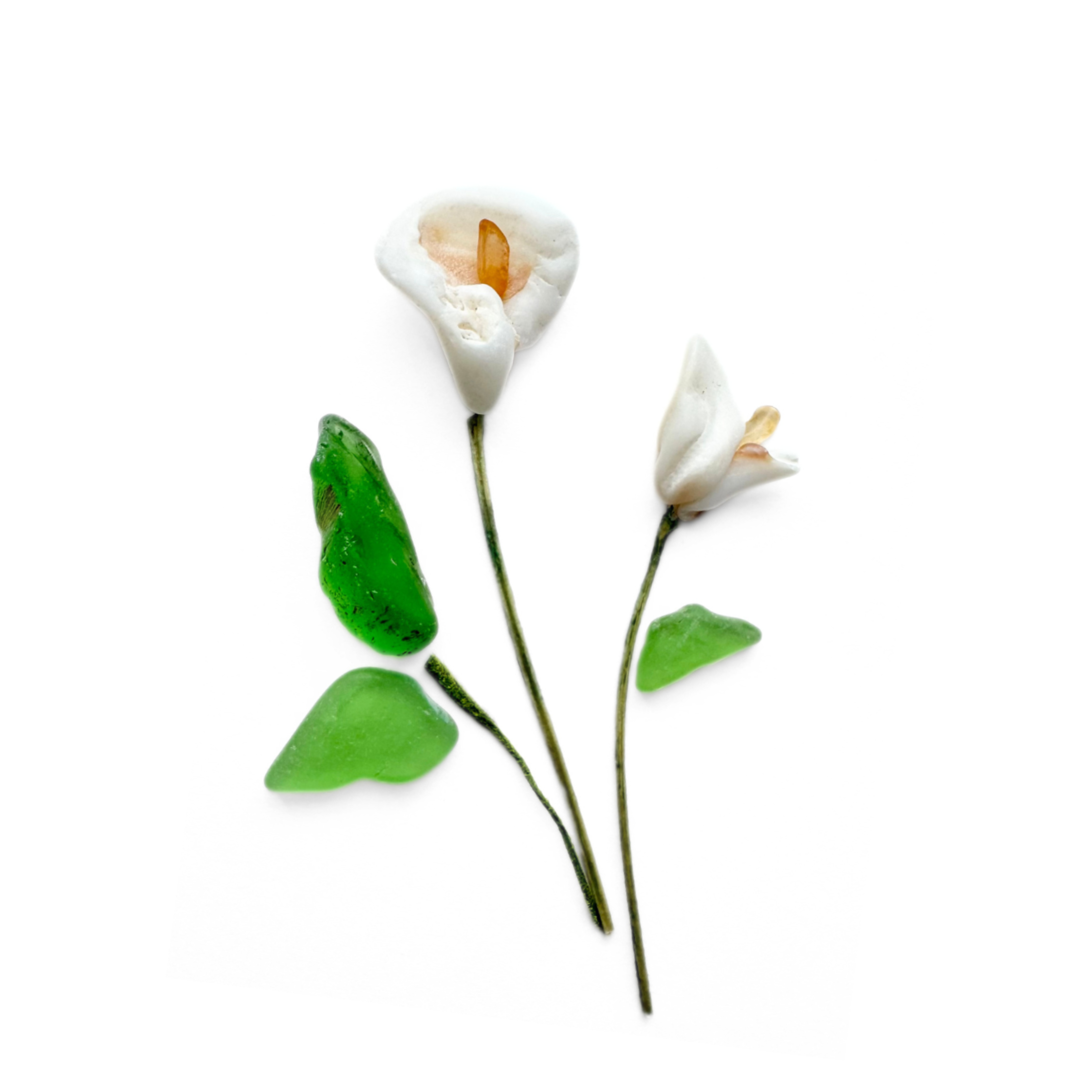 Two white sea glass calla lilies with green leaves and slender natural stems on a white background.