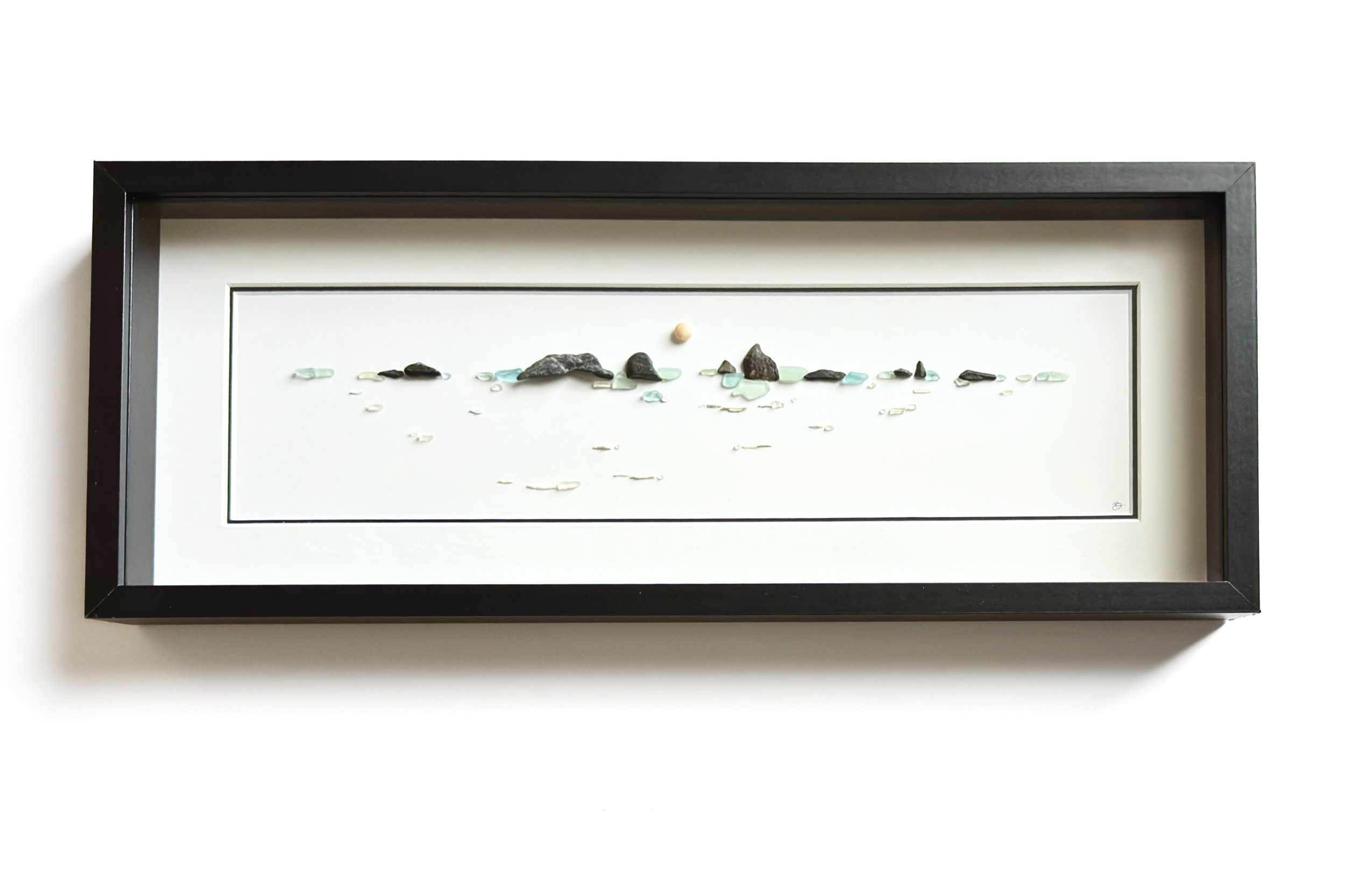 Framed panoramic coastal horizon created with sea glass, beach stones, and delicate water details.