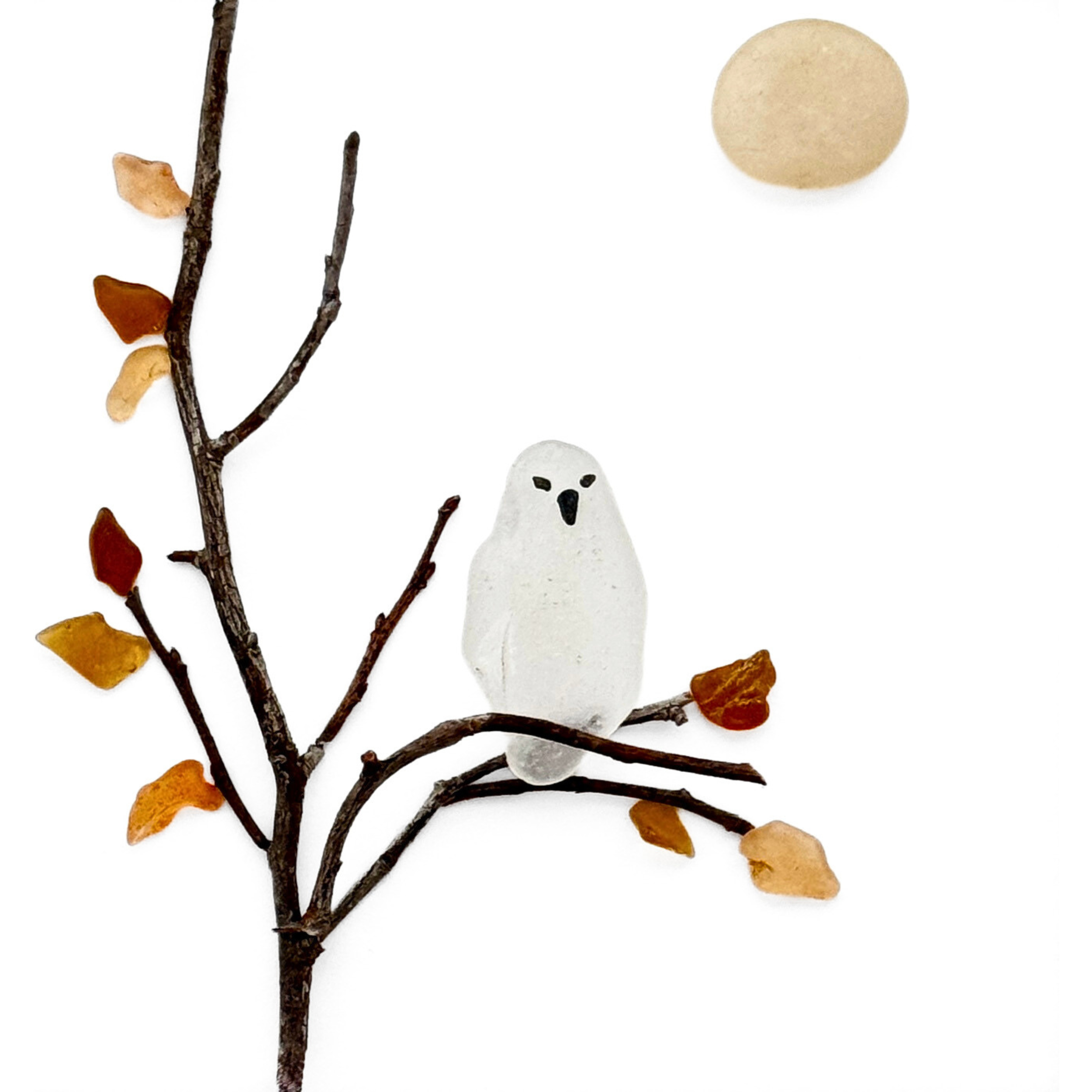 A translucent sea glass owl perches among autumn branches beneath a pale full moon.