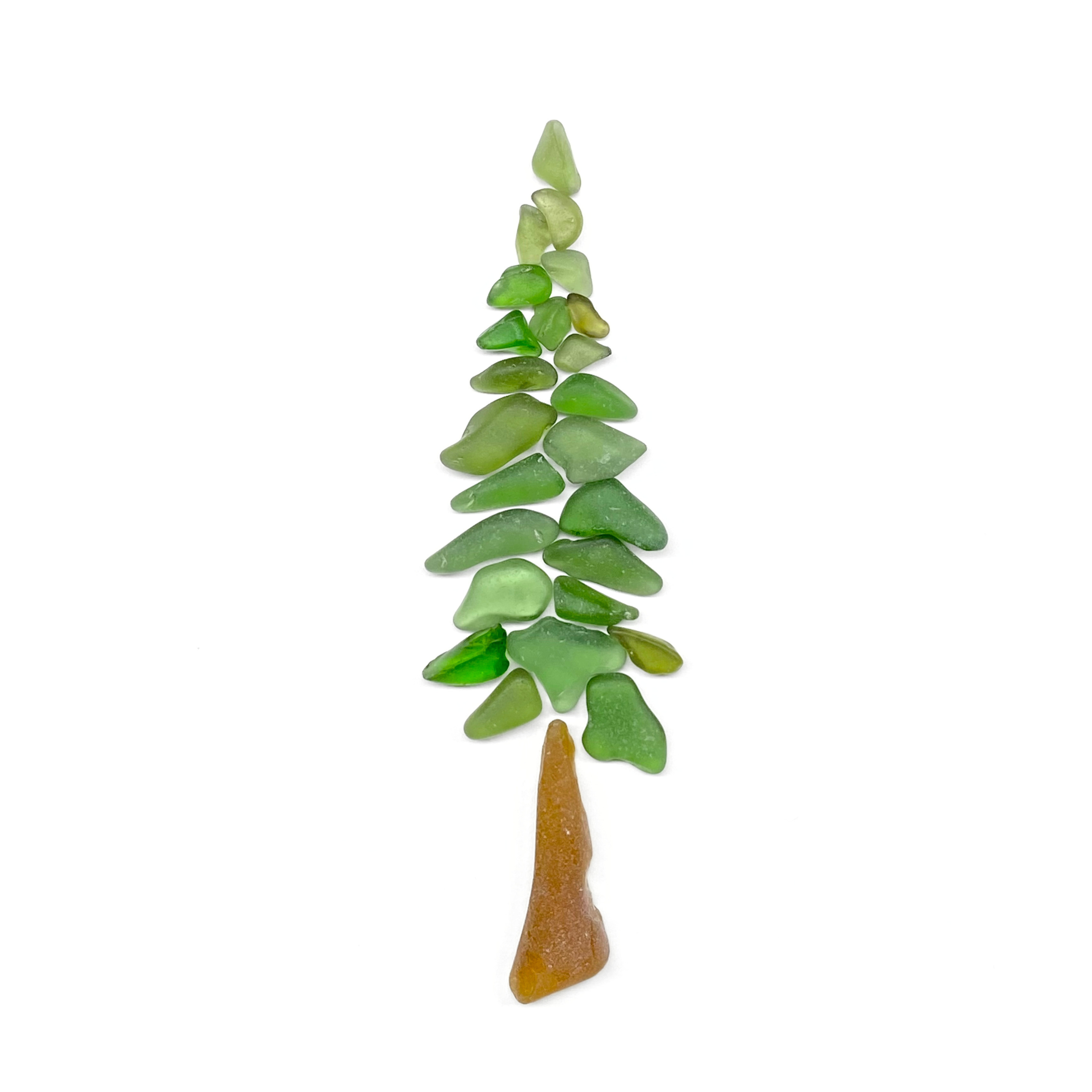 A stately evergreen redwood tree created from layered shades of green sea glass and warm amber glass tree trunk.
