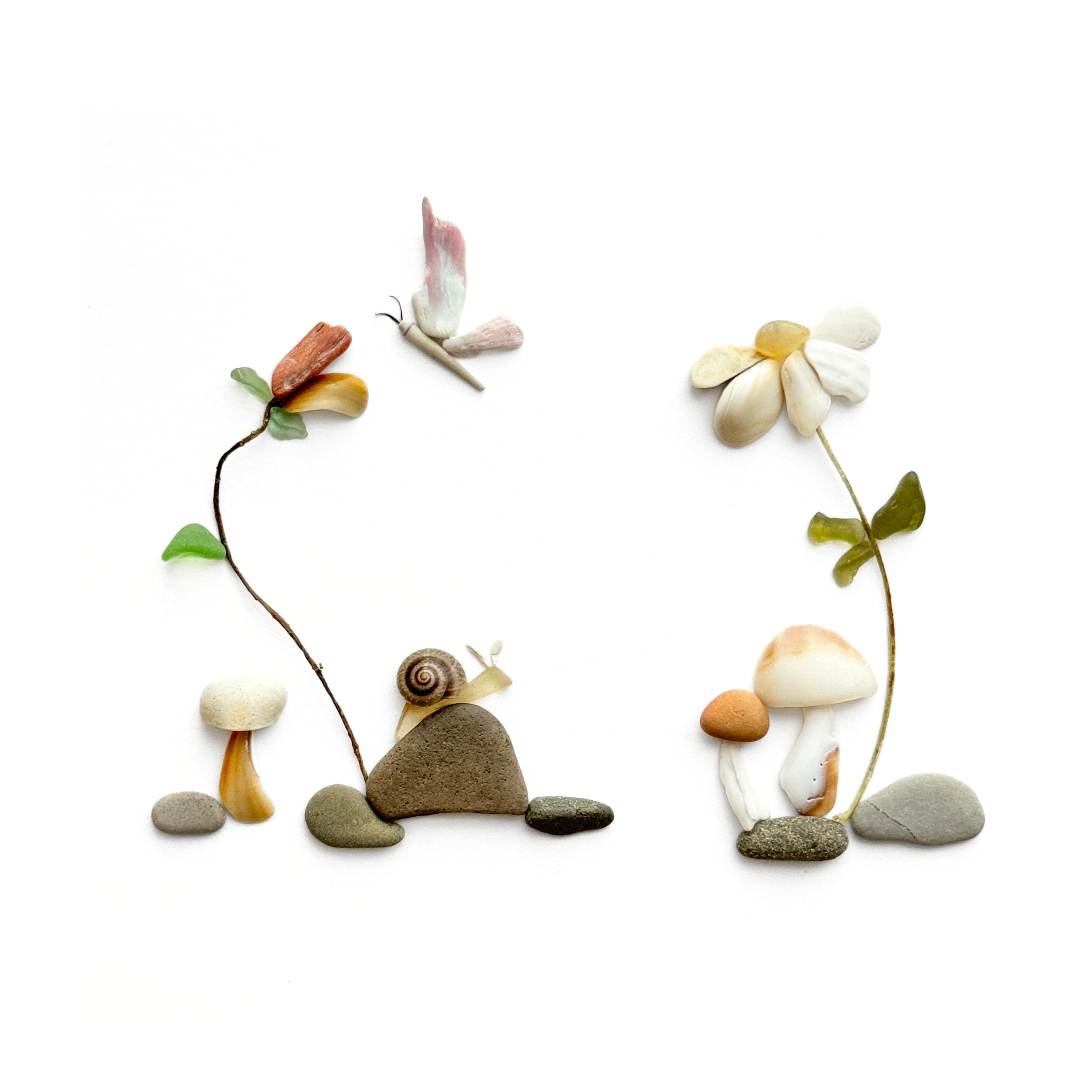 A tiny snail explores a whimsical mushroom garden created with sea glass, shells, beach stones, and preserved flowers.