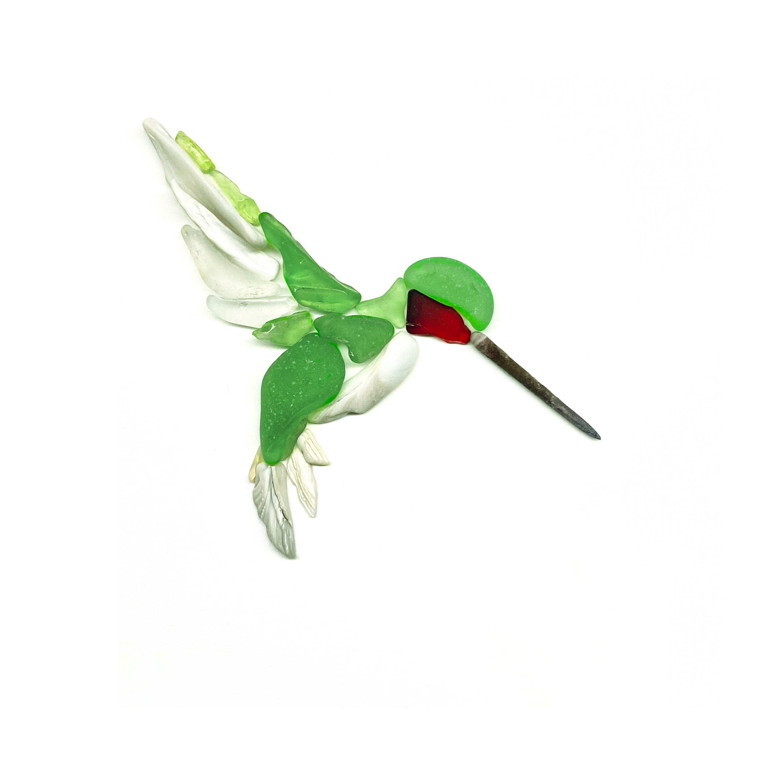 A ruby-throated hummingbird takes flight, created from naturally shaped sea glass in vivid shades of green.