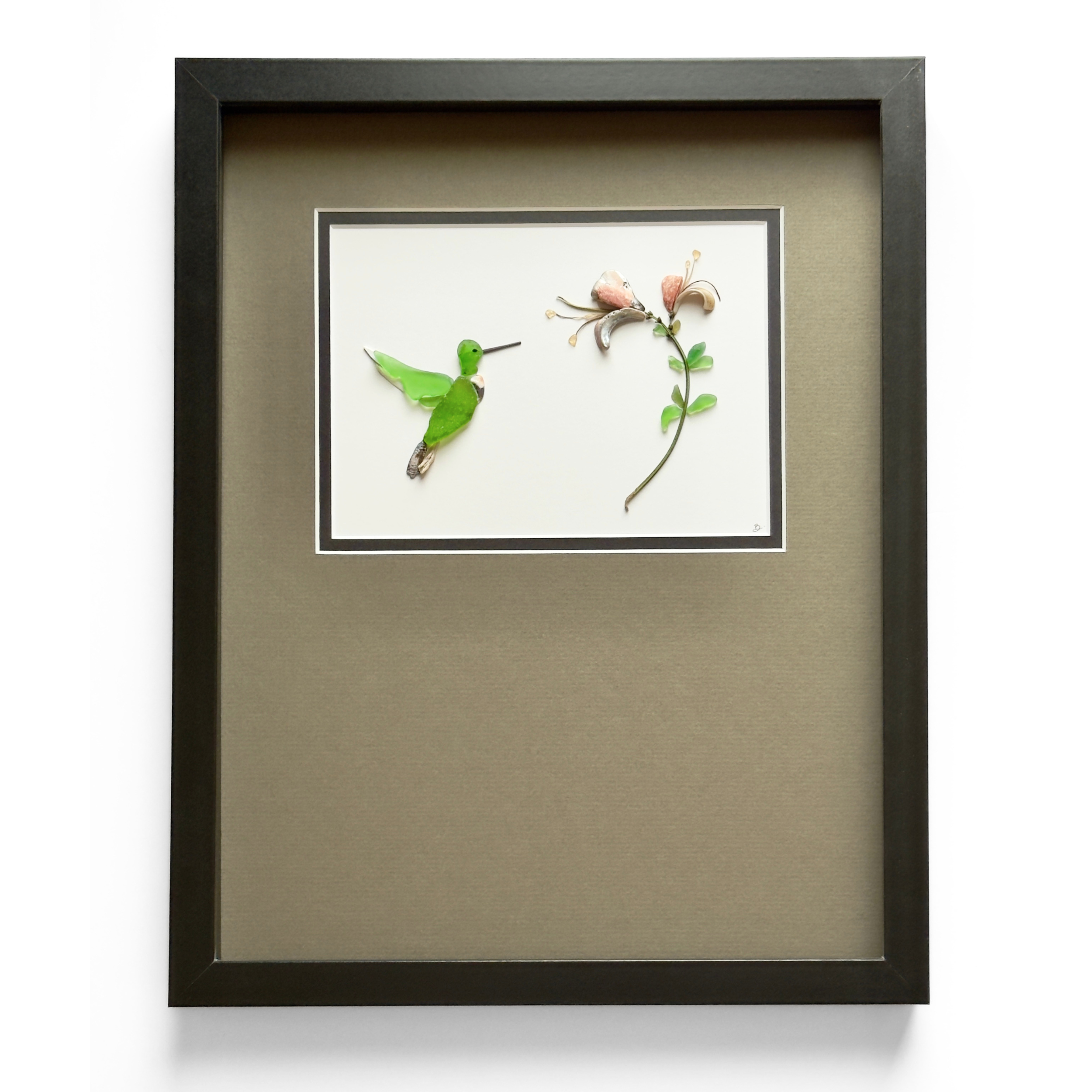 The finished hummingbird and blossoms, presented in a dark frame with a warm neutral mat.