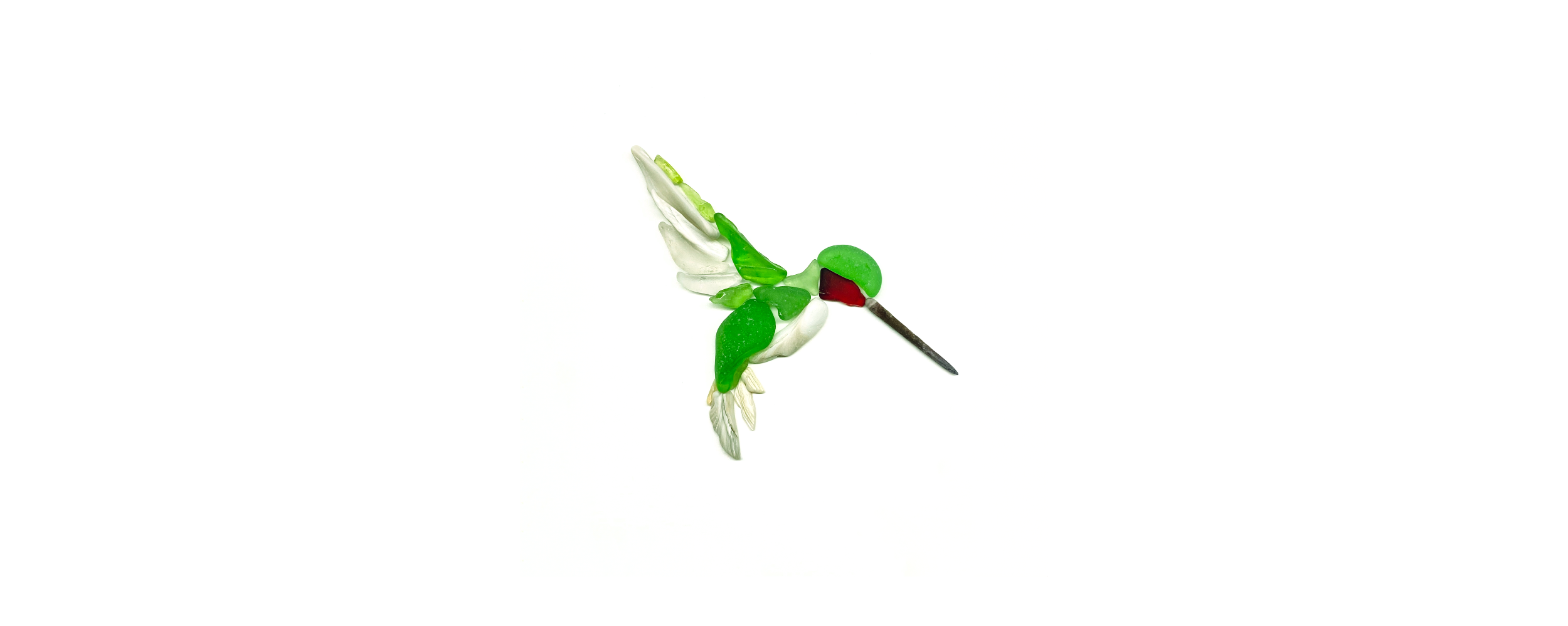 Sea glass hummingbird with green wings and a red throat in mid-flight