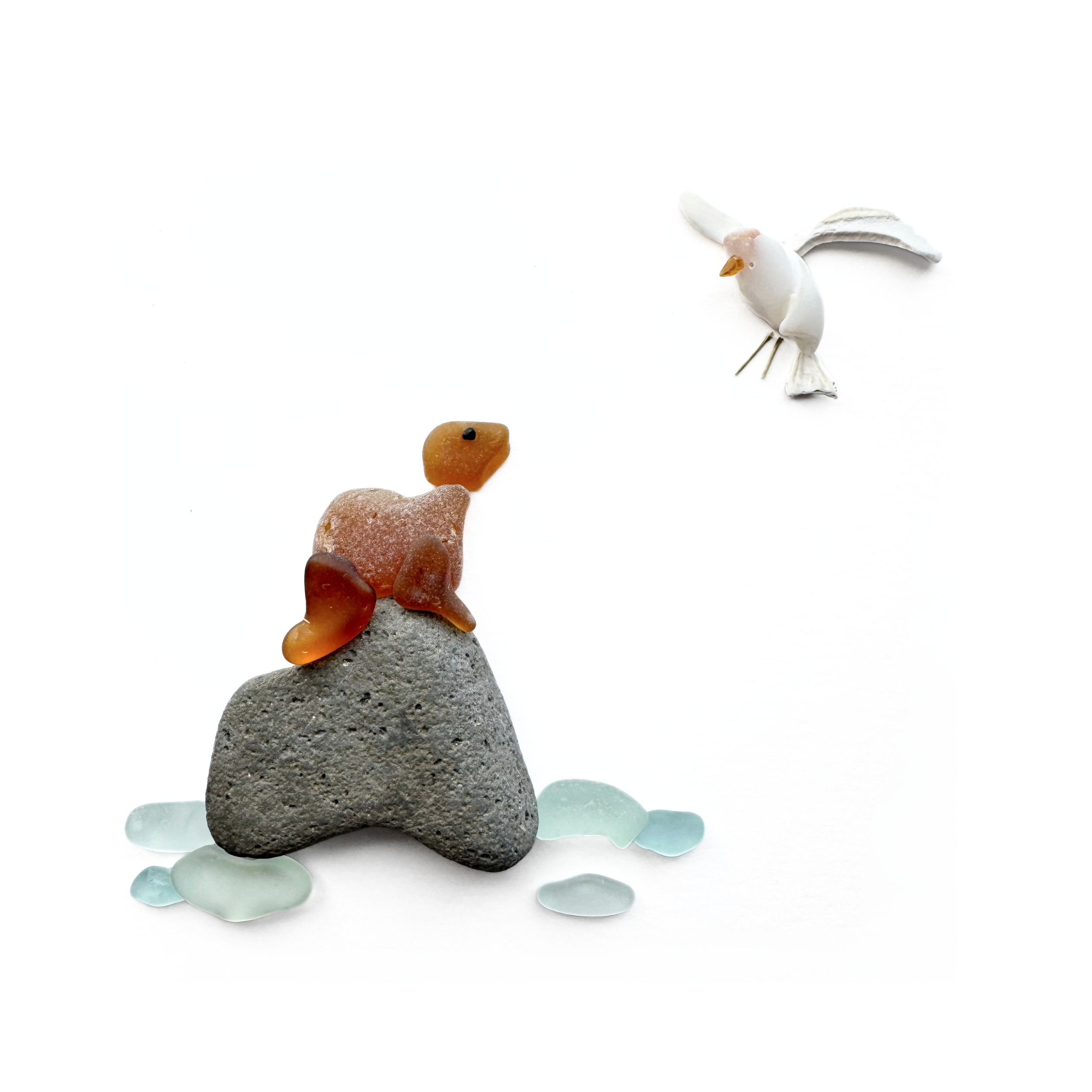 Brown sea glass sea lion resting on a coastal rock as a seabird flies overhead.