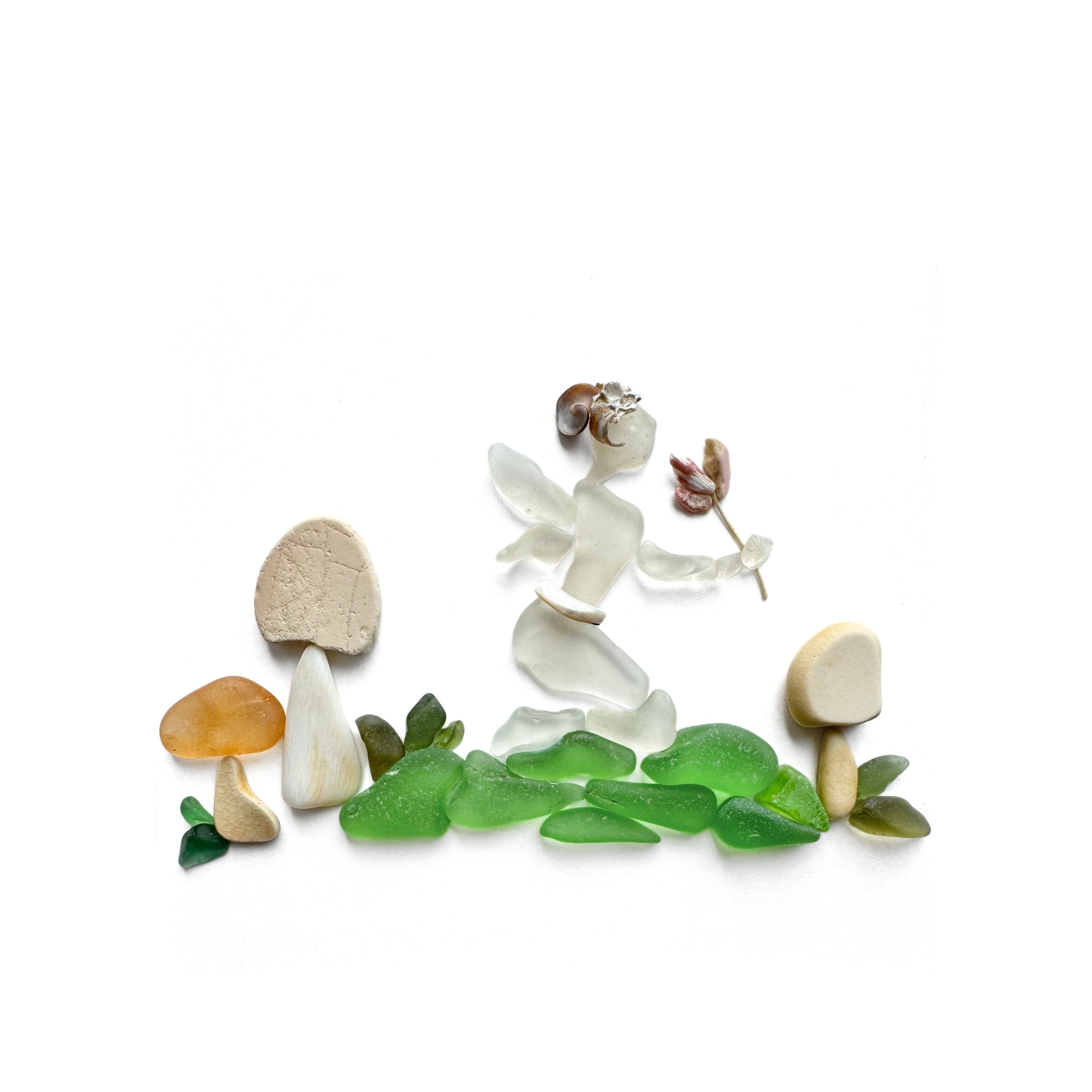 Original sea glass artwork featuring a tiny woodland fairy with translucent wings carrying a flower above green sea glass, surrounded by three mushrooms against a white background.