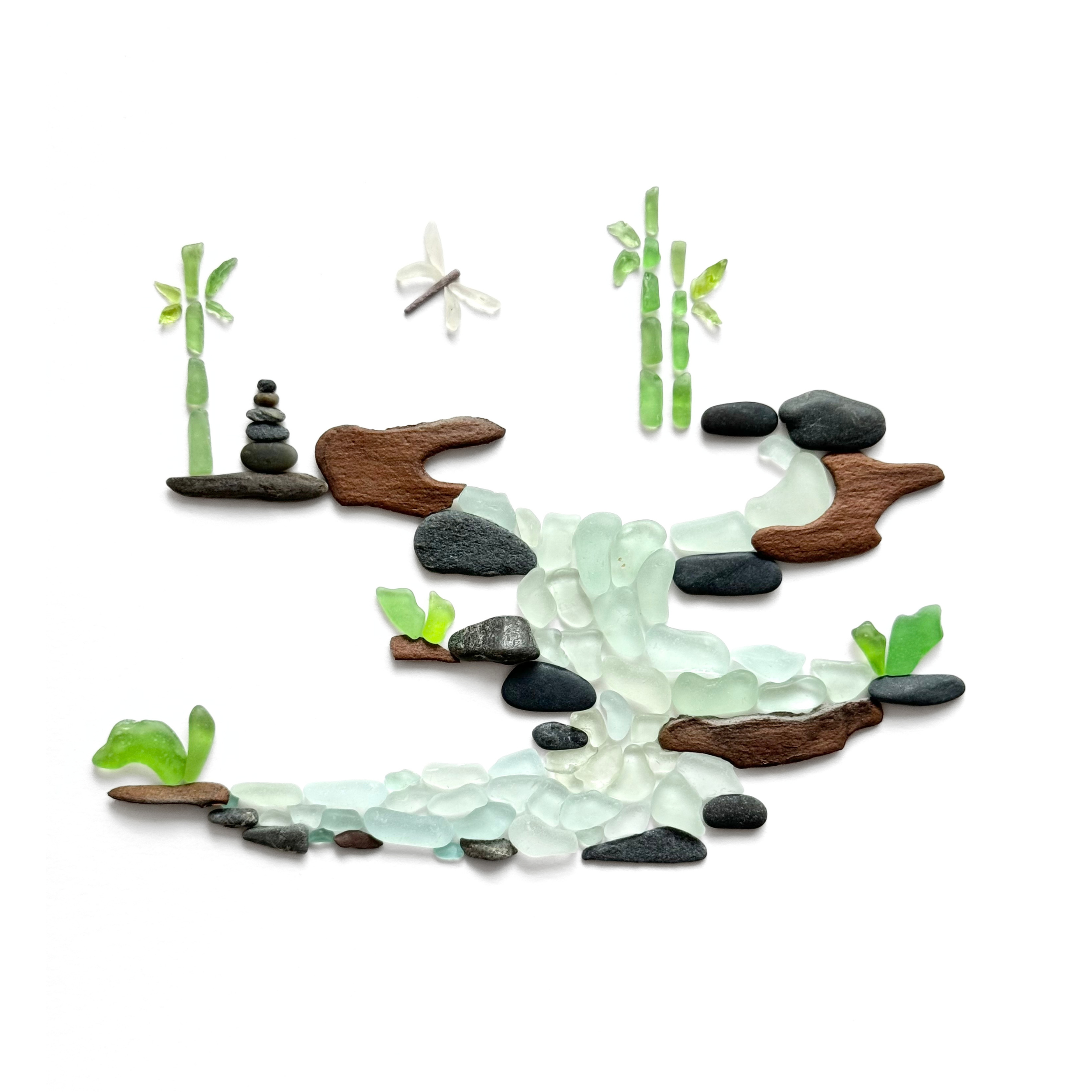 Minimalist sea glass bamboo garden with a winding stream, tree bark, stones, and a dragonfly on a white background.