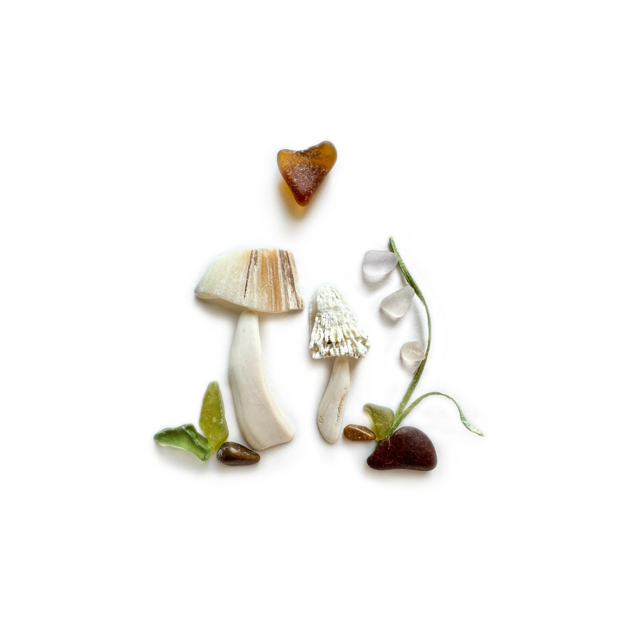 A woodland gathering of mushrooms created with sea glass, shells, stones, and delicate botanical details.