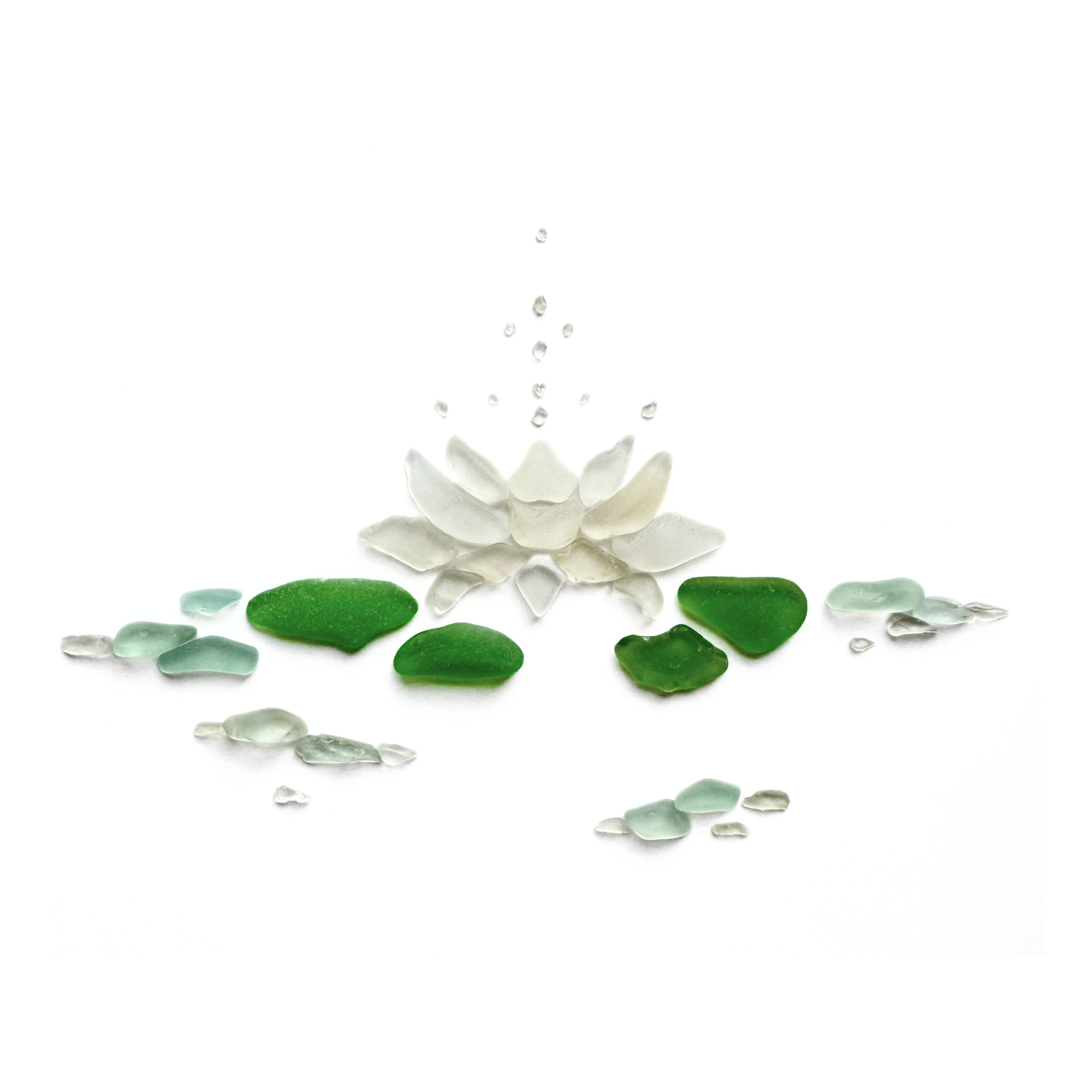 White sea glass lotus flower surrounded by green lily pads and clear glass droplets on a white background.
