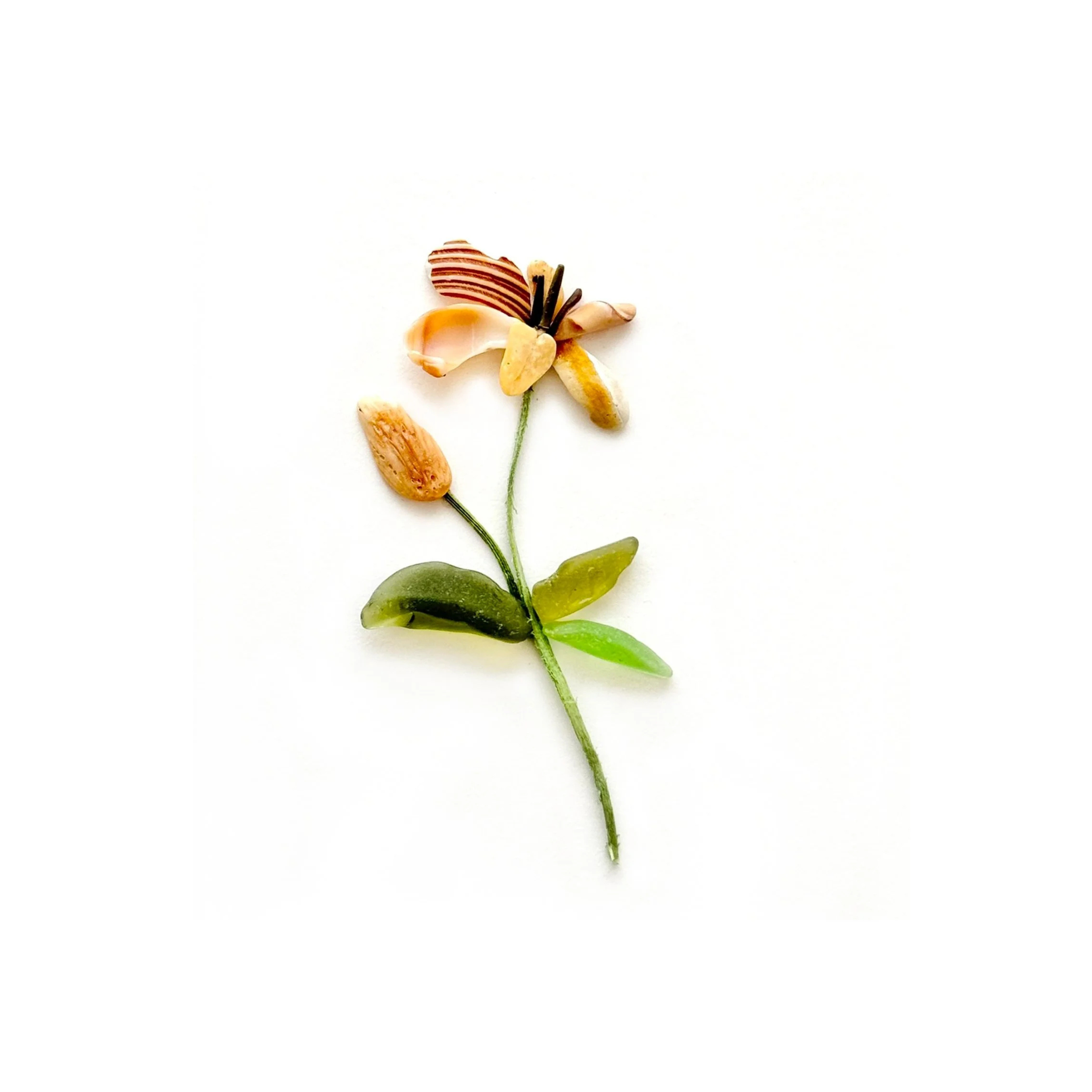 Orange sea glass tiger lily with green leaves on a white background.