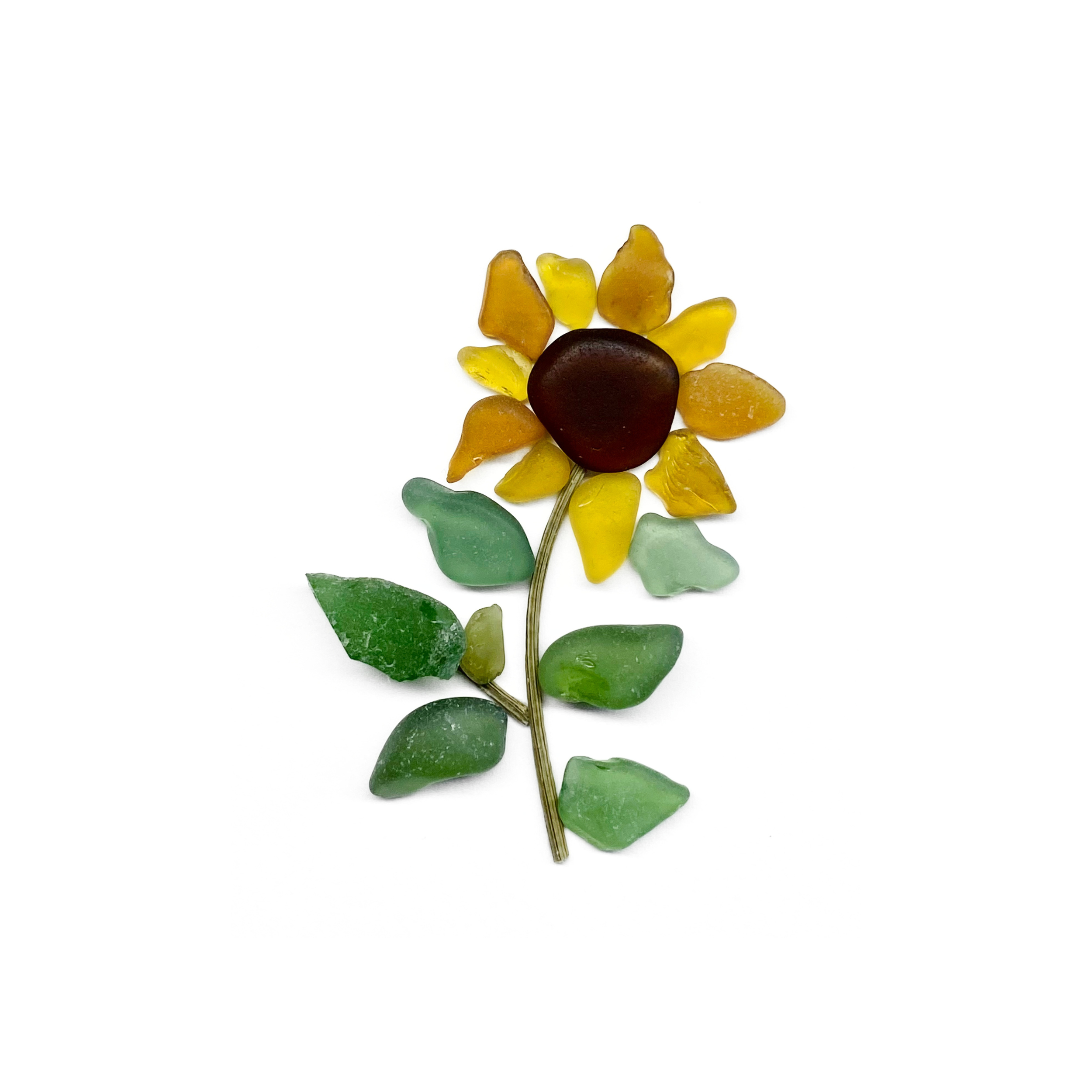 Golden sea glass sunflower with a dark brown center and green leaves on a white background.