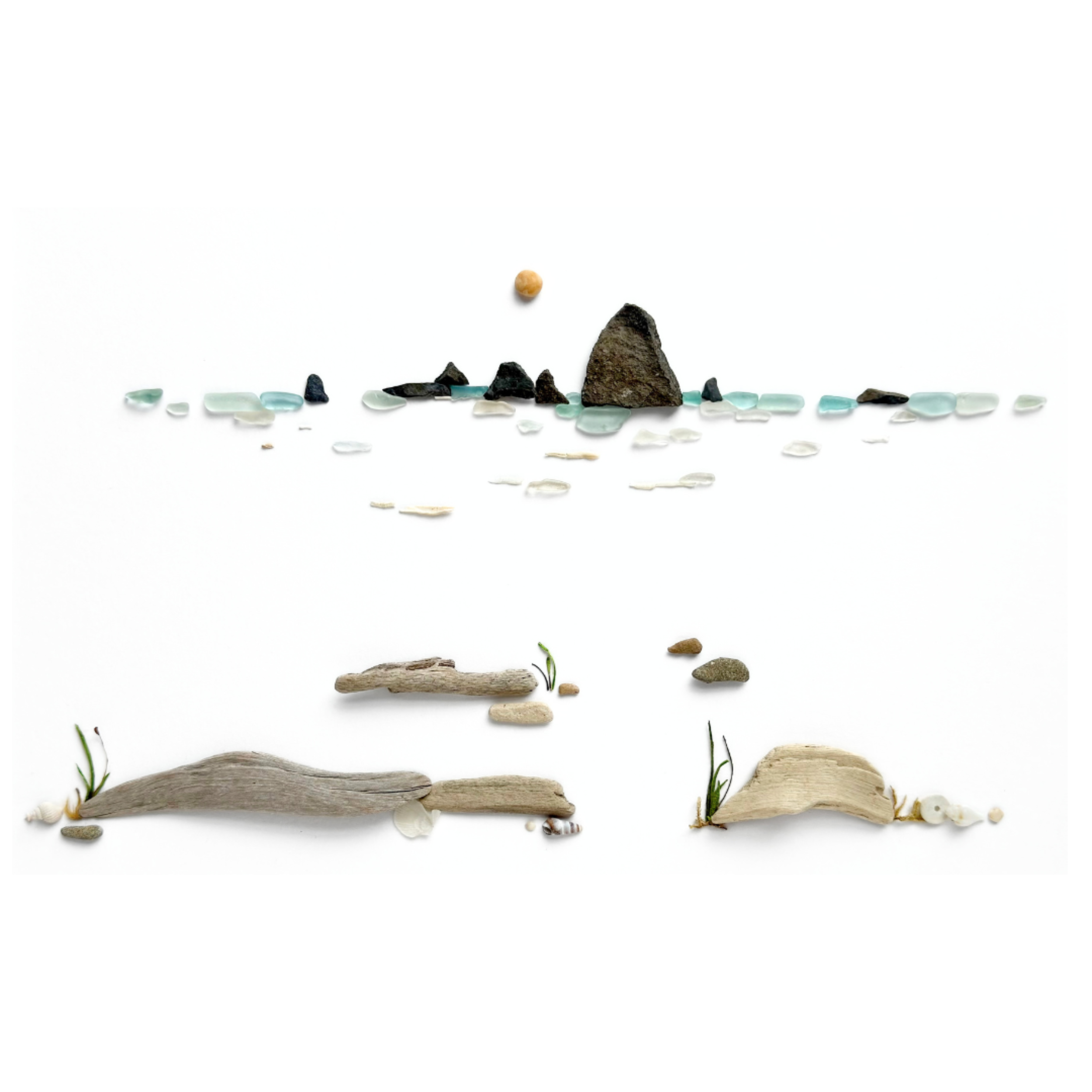 Abstract coastal horizon created with sea glass, beach stones, driftwood, and delicate water details.