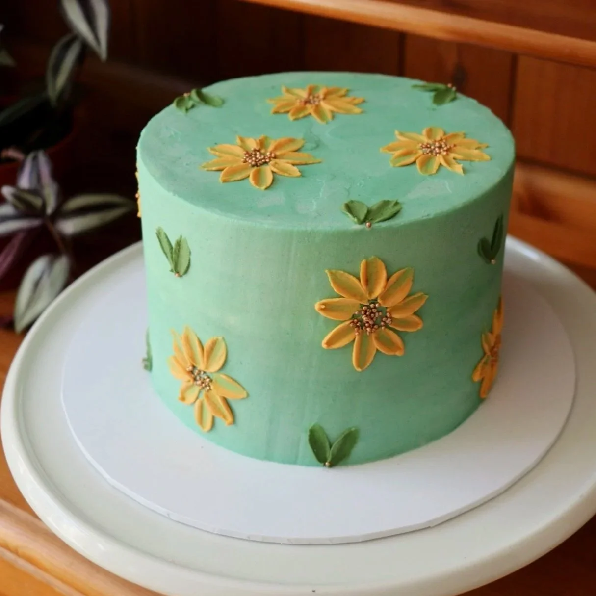 green and yellow sunflower cake painted with buttercream for a celebration