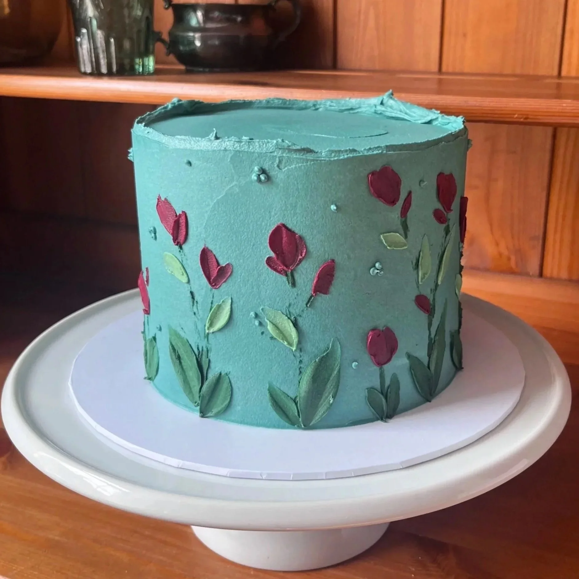 Colourful buttercream celebration cake with pink flowers