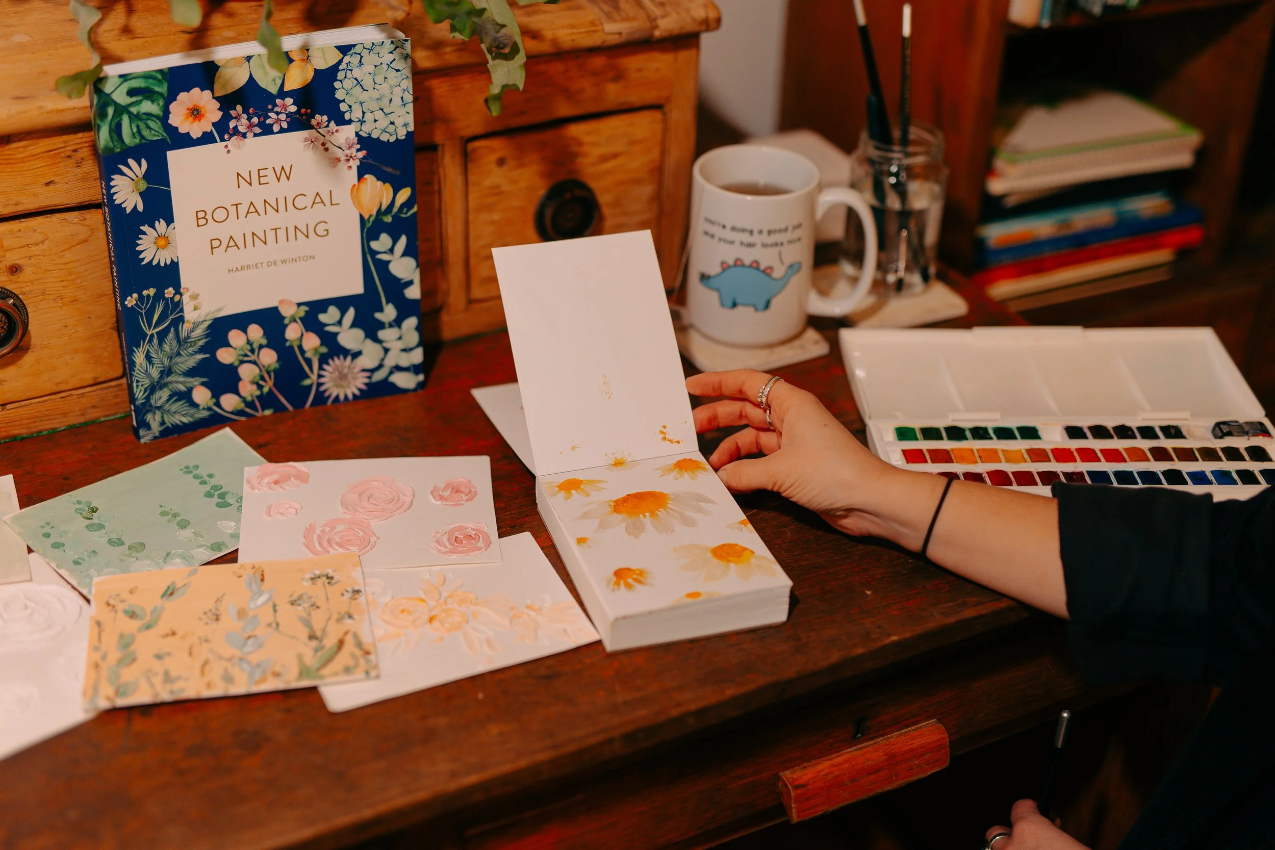 A cake designers design book with watercolour paintings and patterns, drawing inspiration from nature to create bespoke vegan wedding cakes