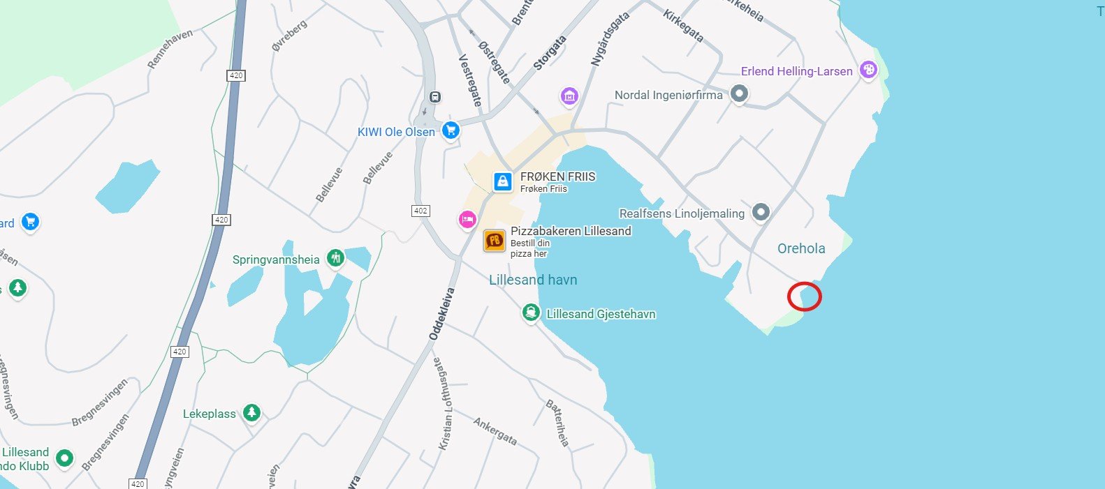 Map of Lillesand, Norway showing streets, water bodies, landmarks such as a harbor, a pizza place, and a marked red circle near the shoreline on the right side of the map.