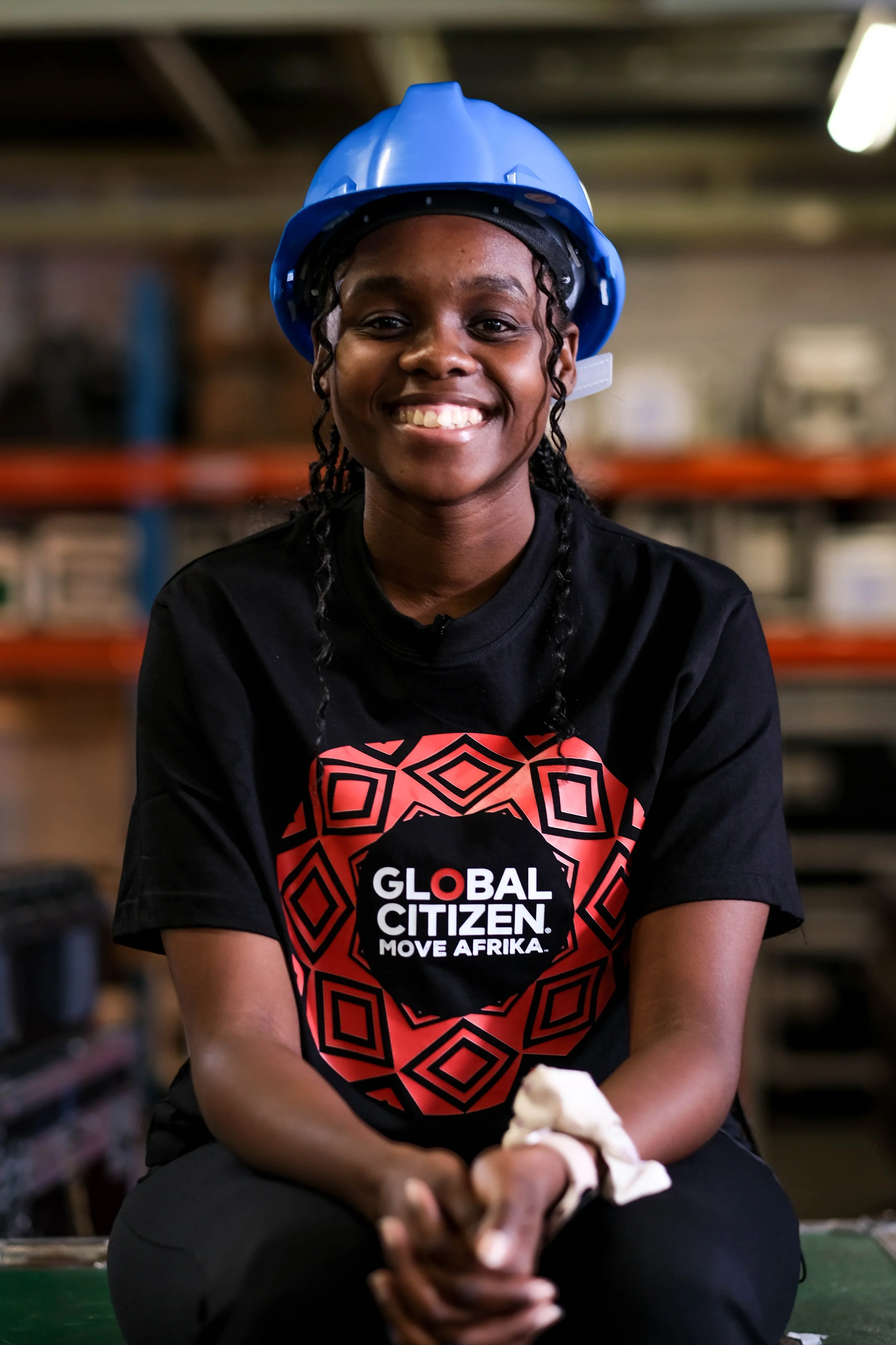  Lulutho Mhlaba wears a hard hat and Global Citizen T-shirt at a technical production facility at Gearhouse. 