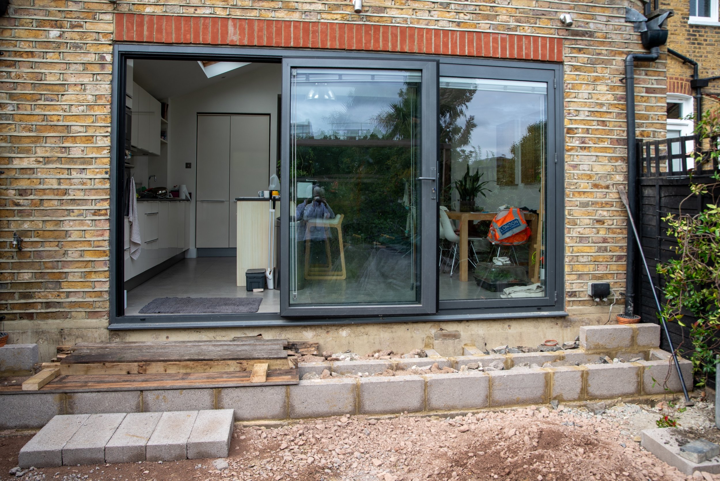 Block work and levels being built outside the patio doors during construction of a Wimbledon back garden by Vlad the Landscaper