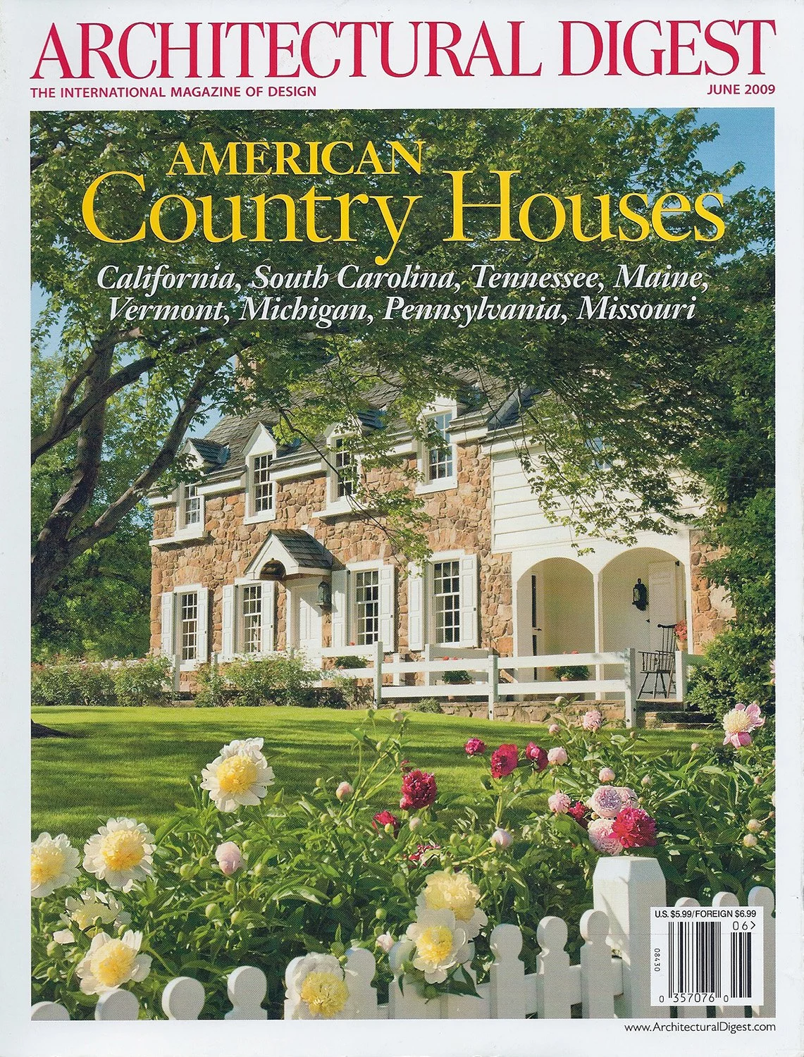 Cover of Architectural Digest June 2009 featuring a stone country house with a white picket fence and garden in bloom