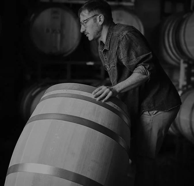 Winemaker with barrel.