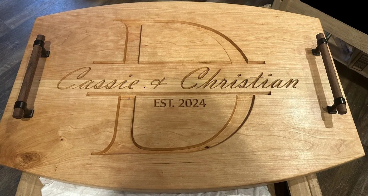 A wooden serving tray with engraved text that reads 'Classic & Christian' and 'EST. 2024', featuring a cross design in the center and two side handles.
