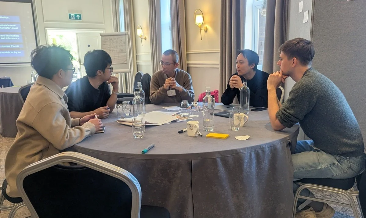 Five people sitting round a table