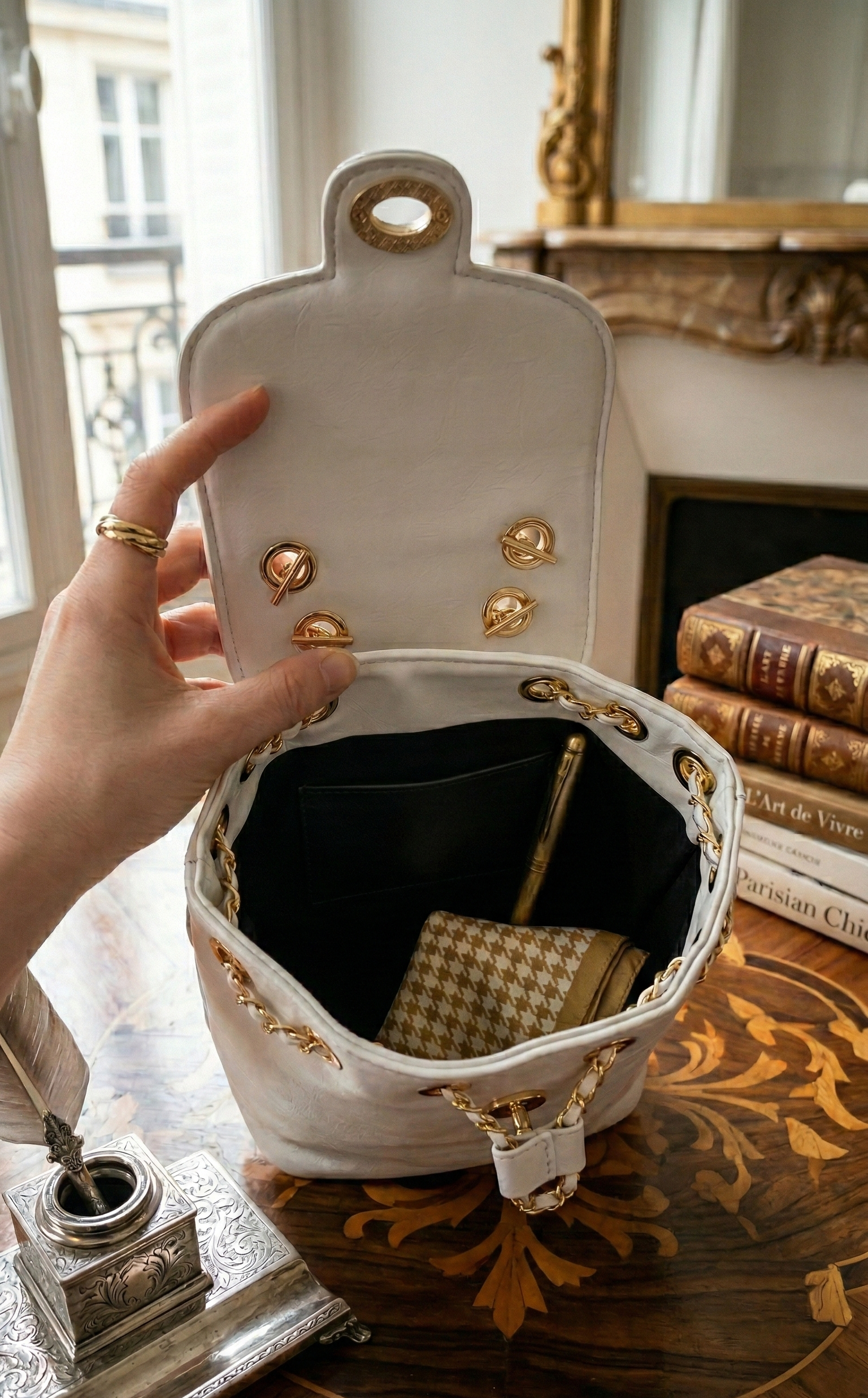 L’Avenue Backpack is a study in quiet luxury, merging the structured silhouette of a classic bucket bag with the practical spirit of a backpack..png