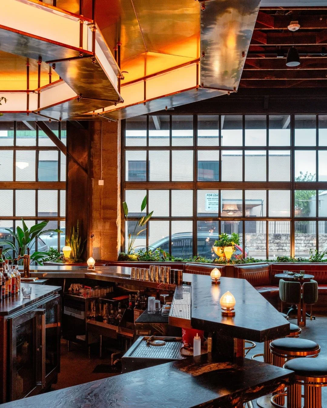 A view of the Red Herring Restaurant Bar & Cocktail lounge with a large industrial window in the background.