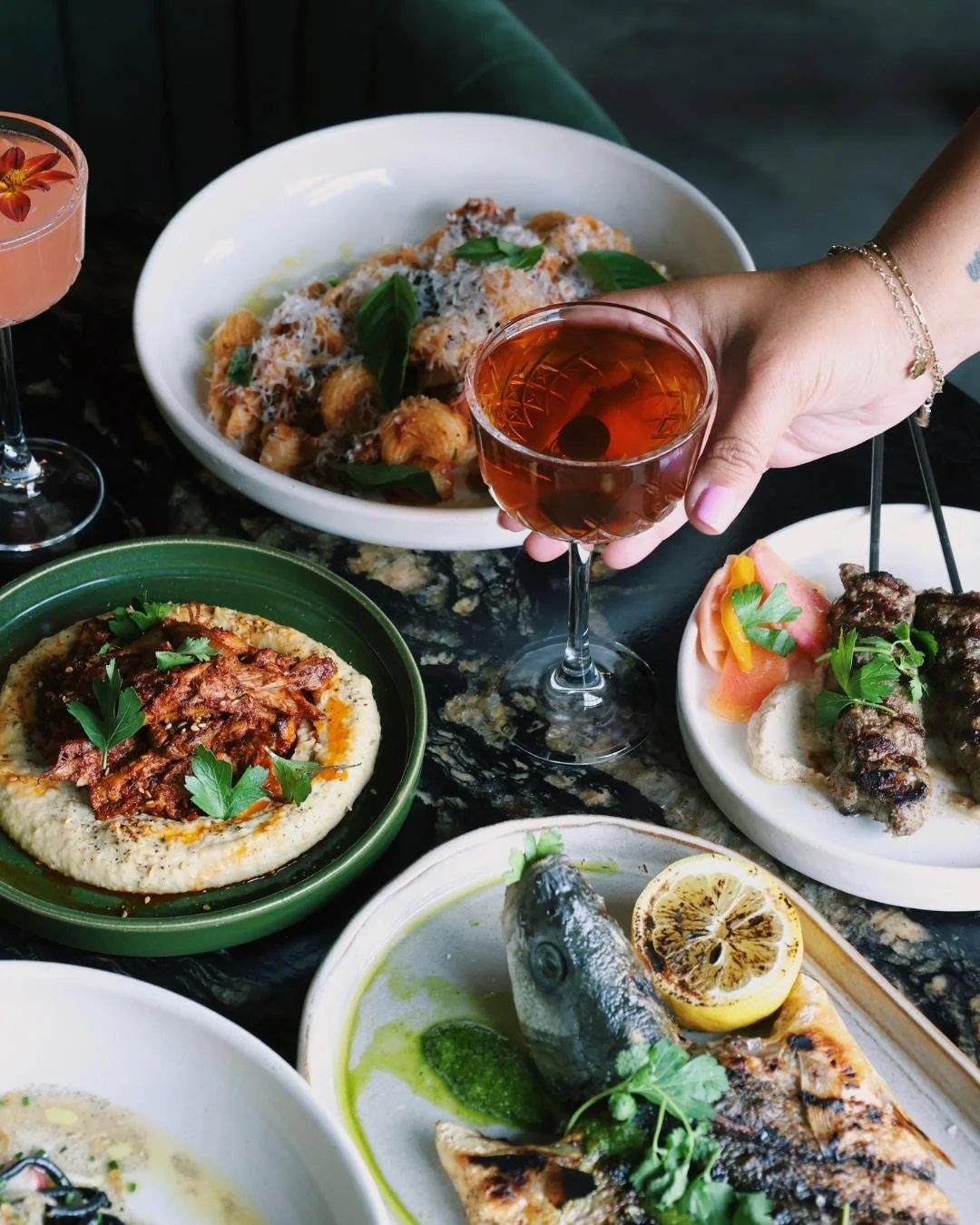 A table scape showing fresh handmade pastas, wood-fired fish, kebabs and small-plates at Red Herring Restaurant