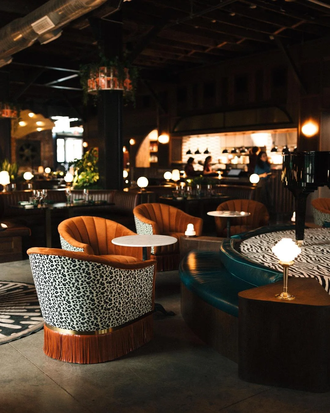 A view of the cocktail lounge chairs surrounding the baby grand piano in the middle of Red Herring Restaurant