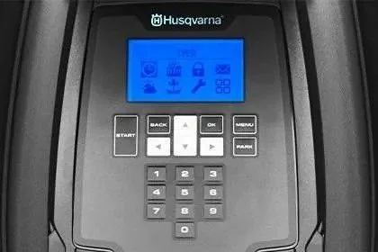 Close-up of a Husqvarna control panel with a blue digital screen and buttons labeled START, BACK, OK, MENU, and arrow keys.