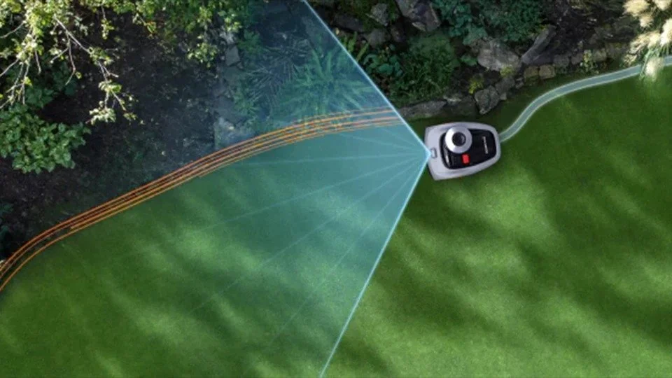 A robotic lawn mower trimming the grass of a backyard lawn.