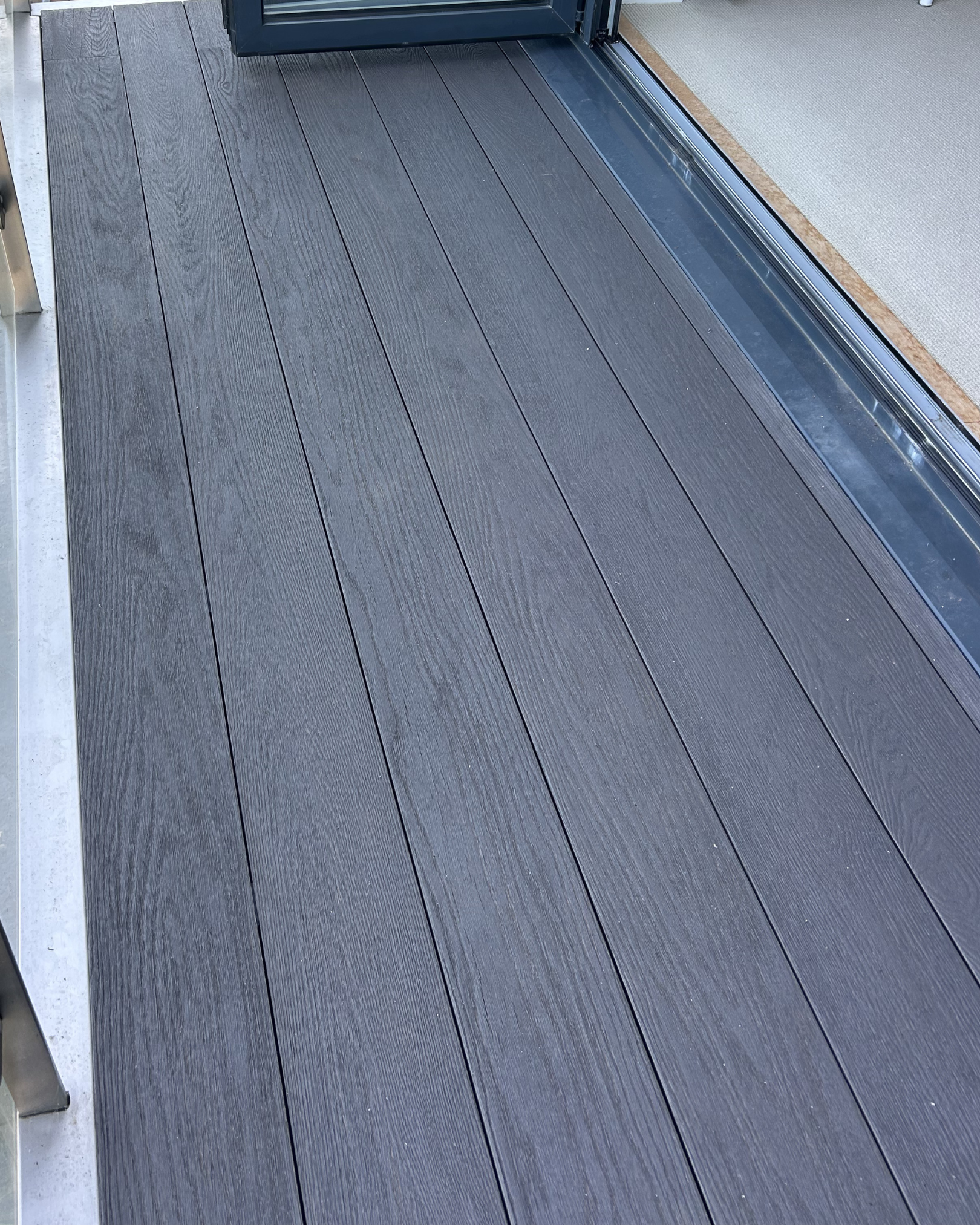 Redux composite decking in the Shadow colour installed on a balcony in Gurnard, Isle Of Wight