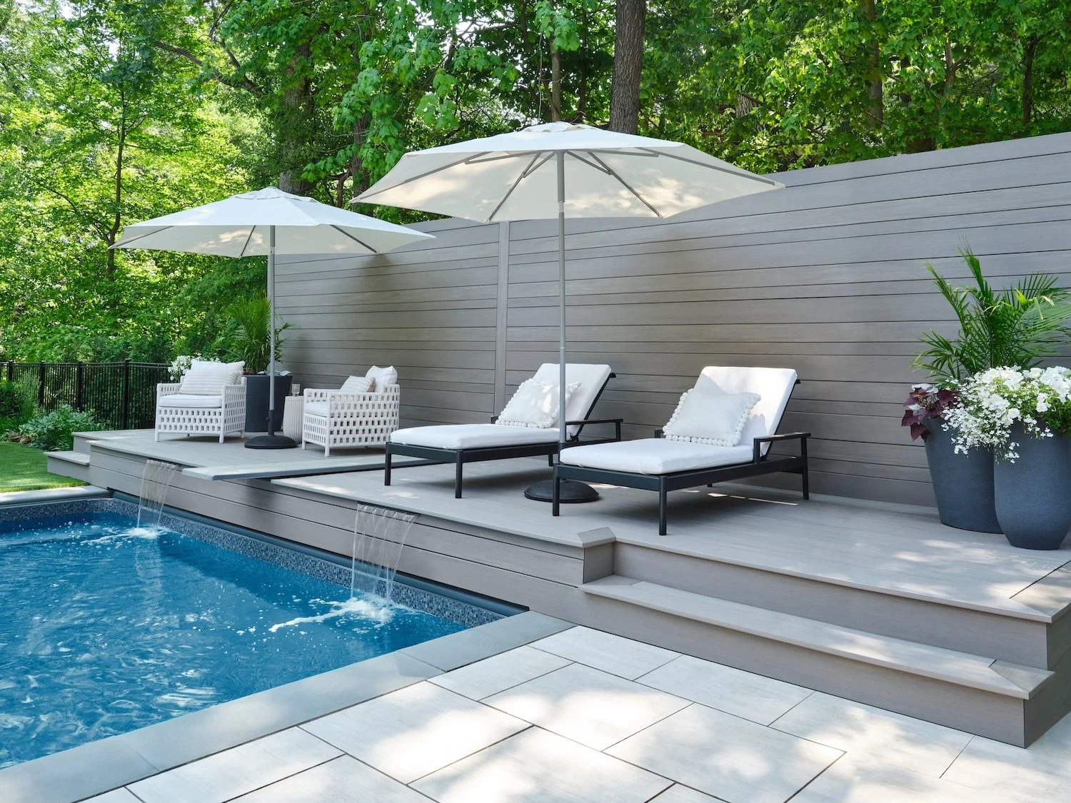 Elements installed round a pool being used as a decking and fence