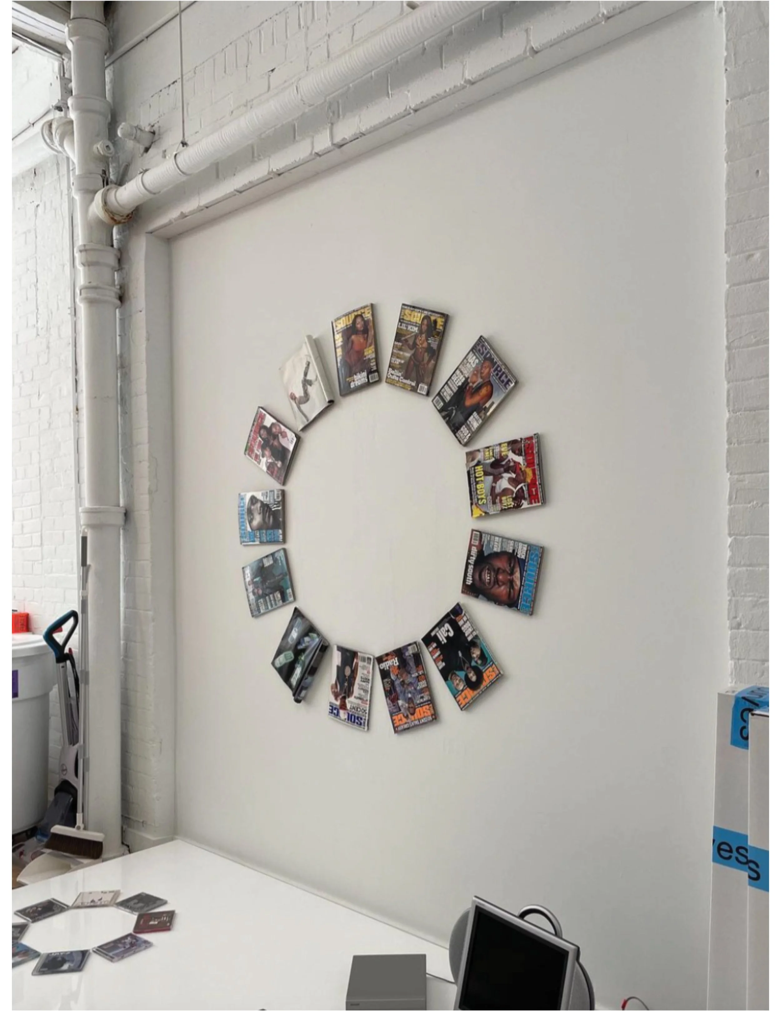 Art directed studio installation with magazine covers arranged in a circular wall display, shot for Curves at Home editorial campaign.