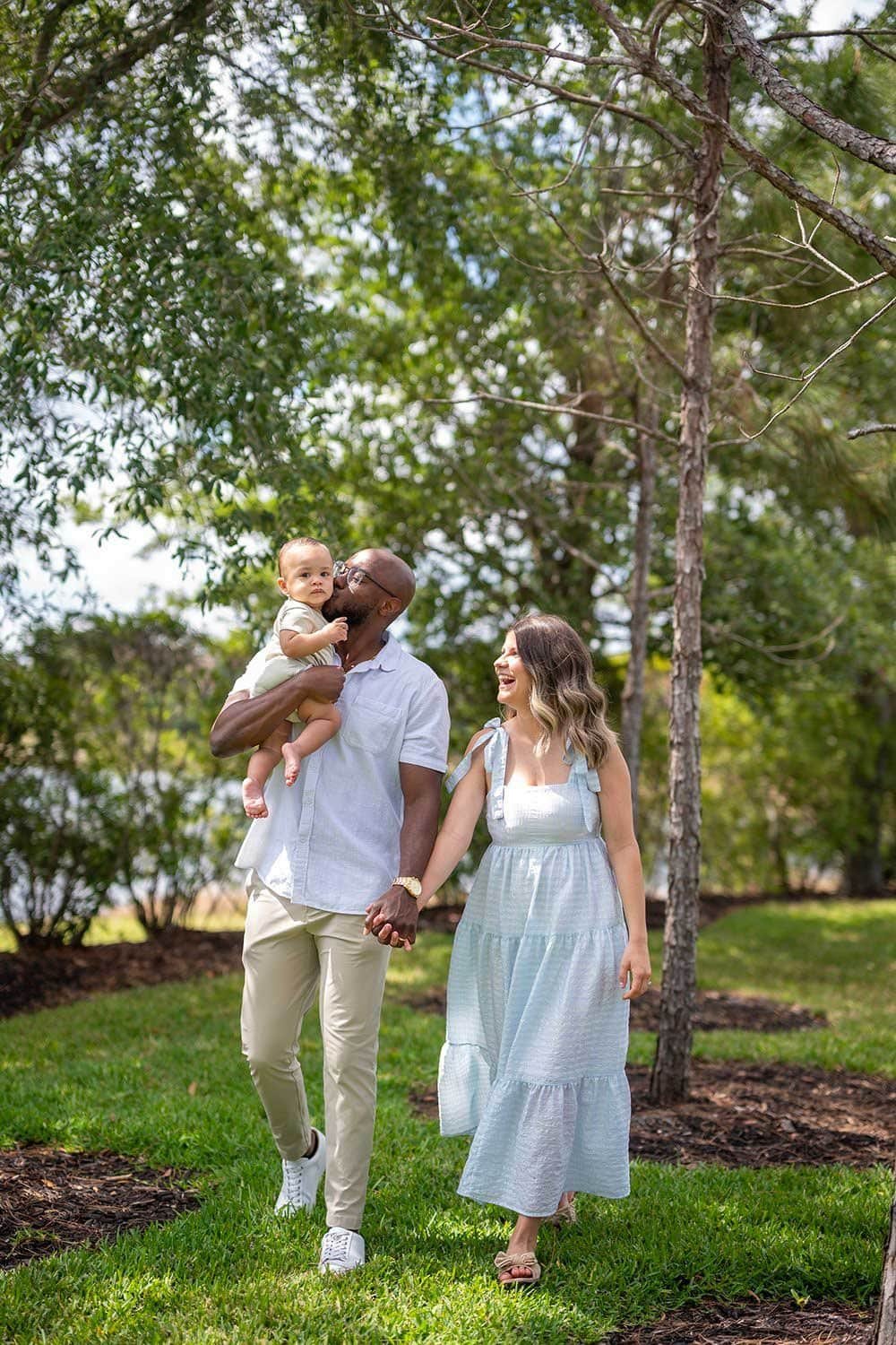 Man and Woman walking with baby - family photographer in Naples FL
