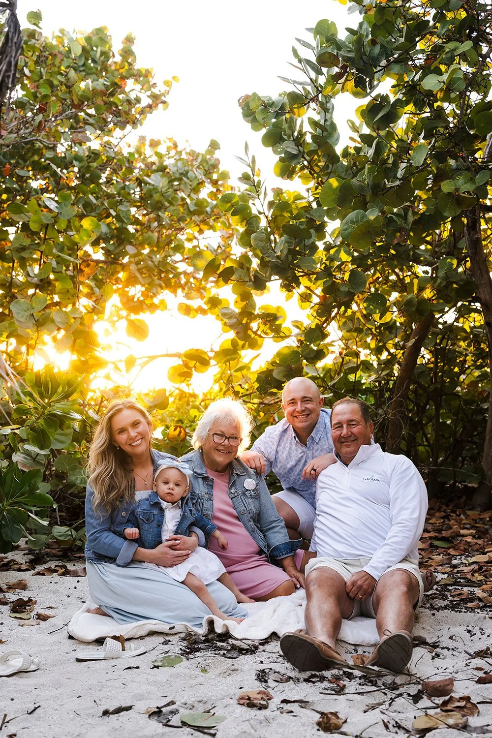 A beautiful multi-generational family photography session at Barefoot Beach in Collier County. Capturing grandparents, parents, and their new grandchild during a Naples family vacation.