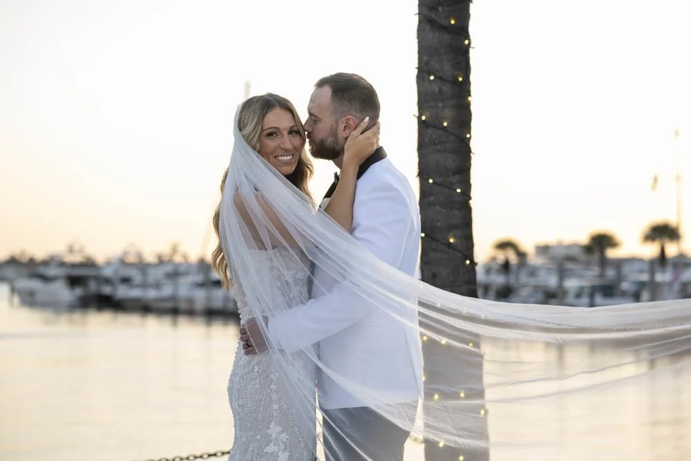 Bride and Groom on the dock with veil blowing in the wind-wedding-photography-naples
