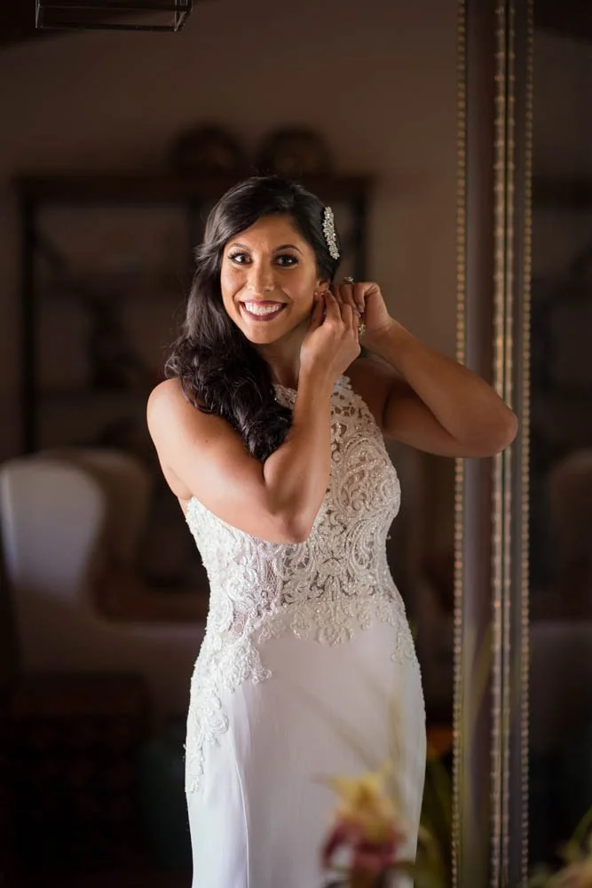 Bride putting in earrings