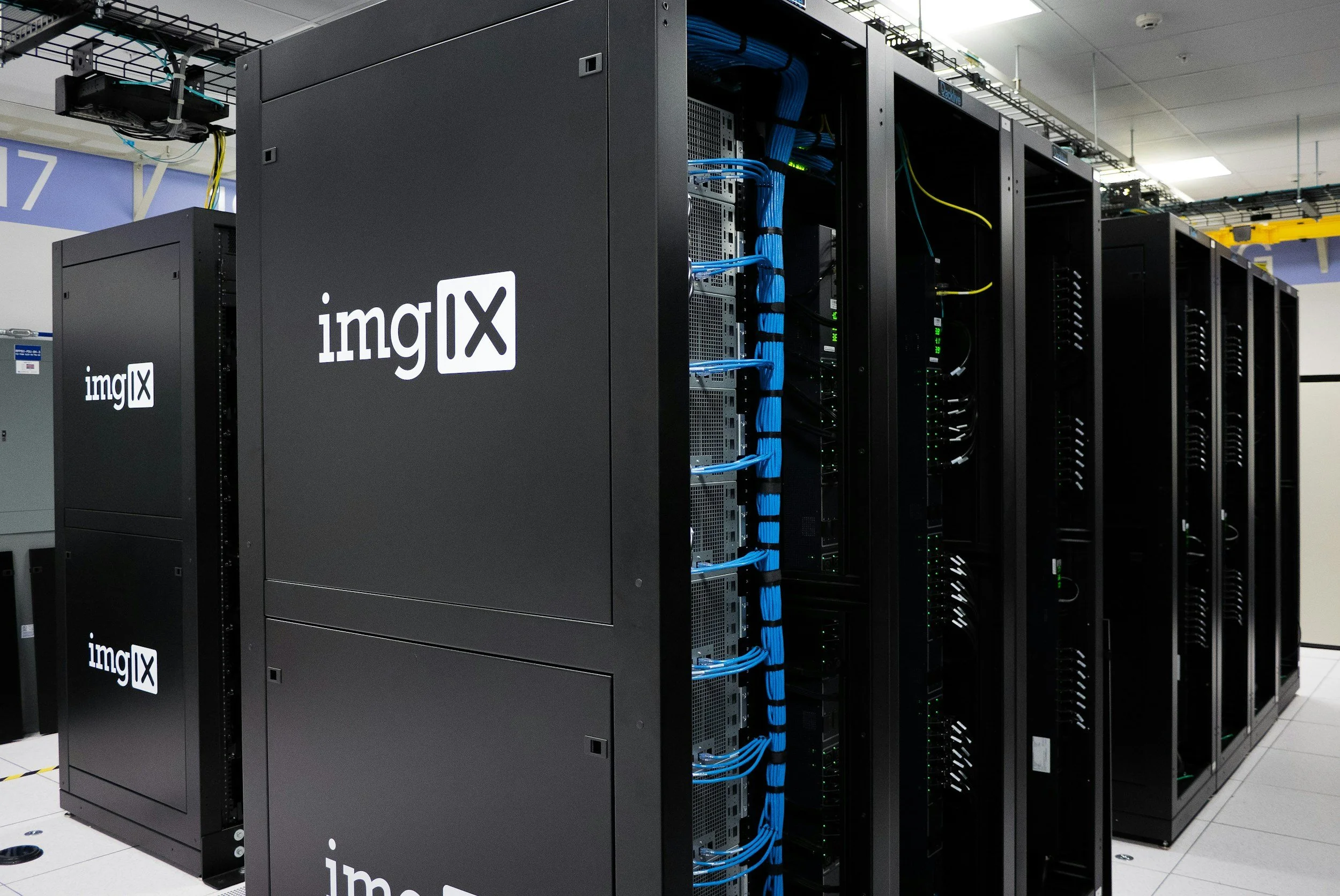 Server racks with blue network cables in a data center, branded with imgIX logo.
