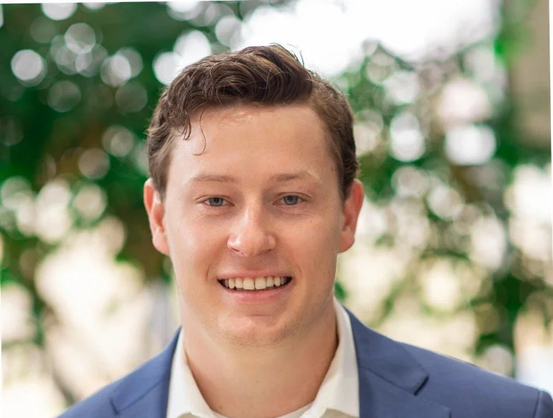 Smiling man in a suit with a neutral background