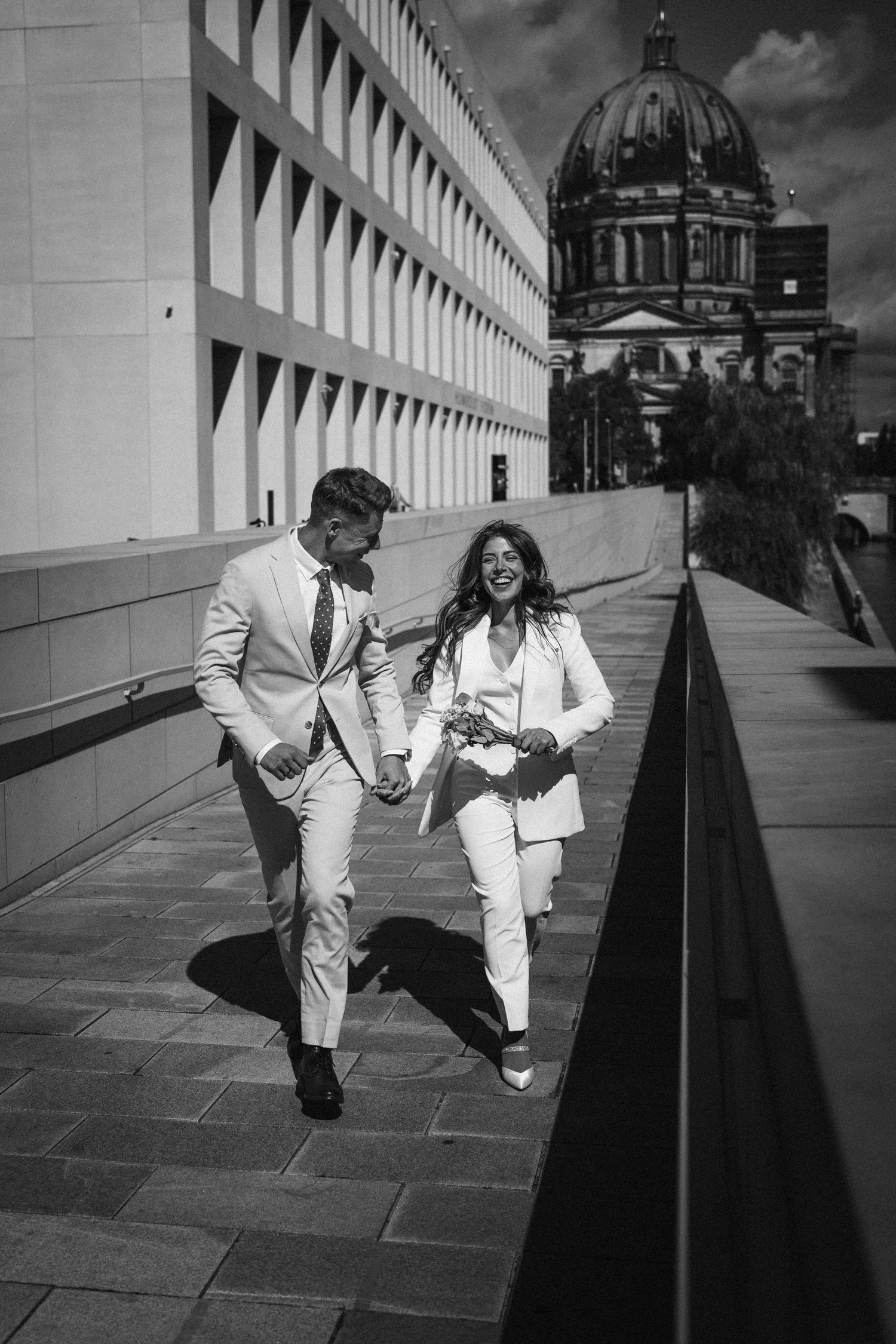 Newlyweds walking hand in hand near the Berlin Cathedral