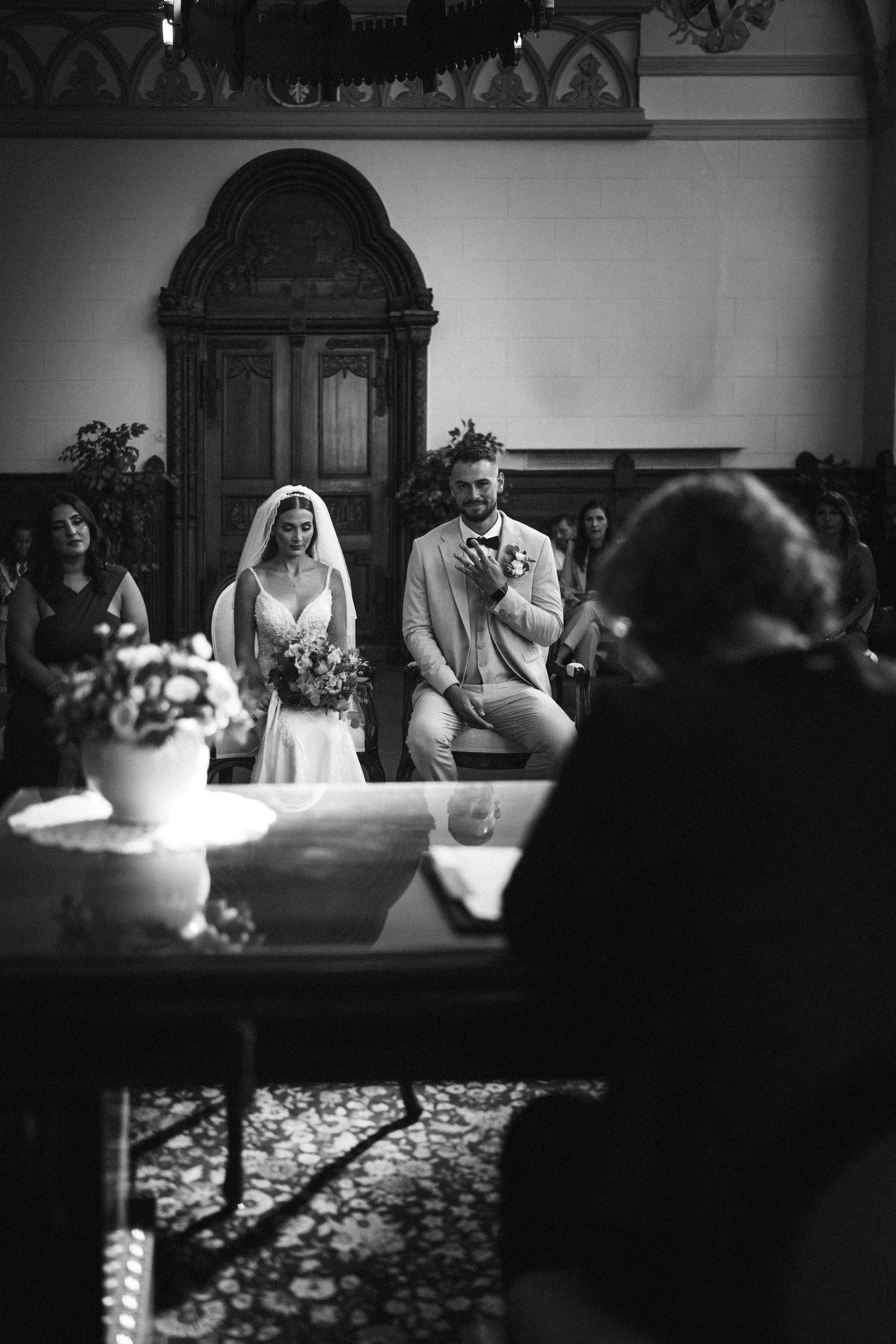 Couple seated in front of the registrar's desk during a civil wedding ceremony in Berlin