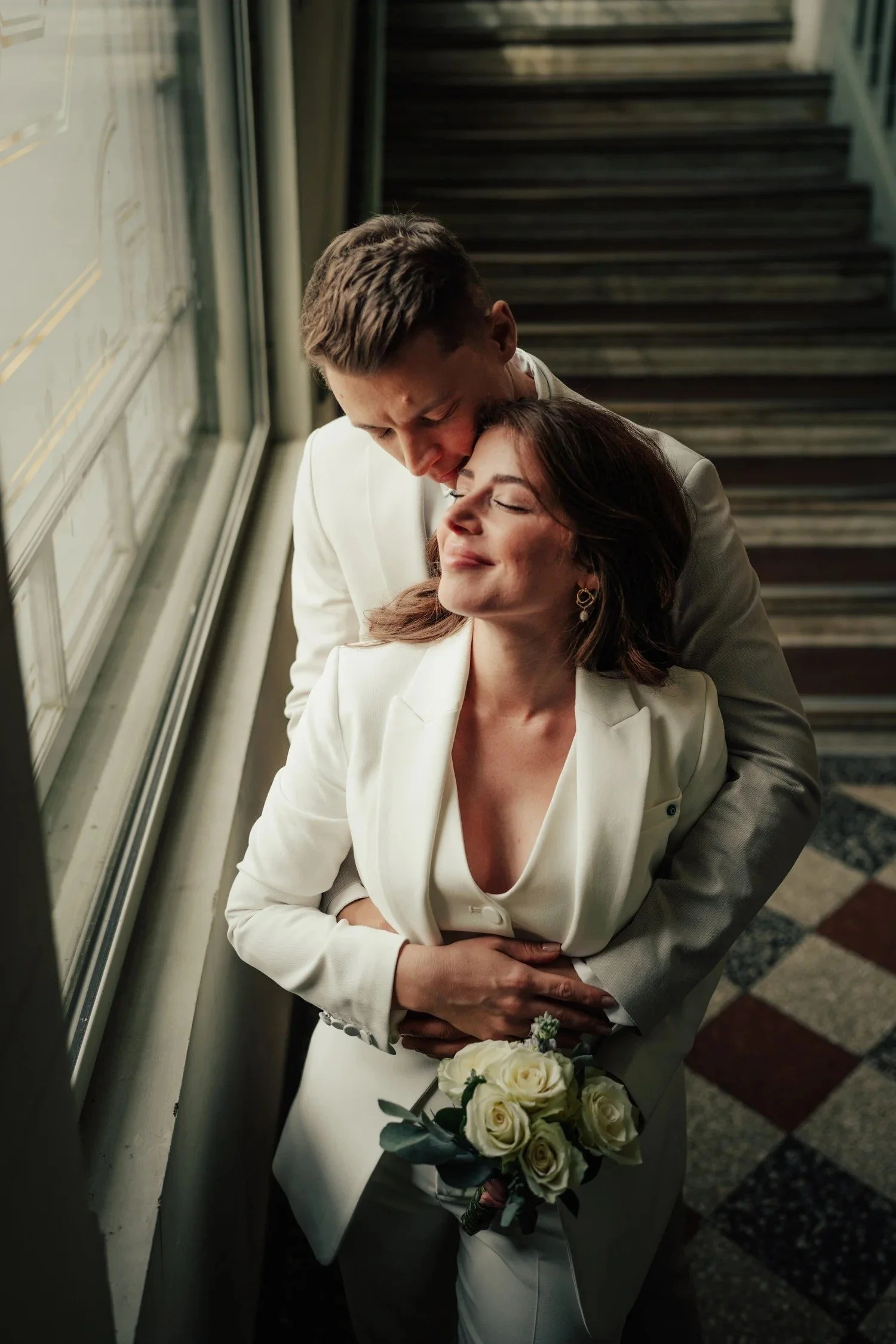Bride and groom in a historic stairwell just after their registry office wedding