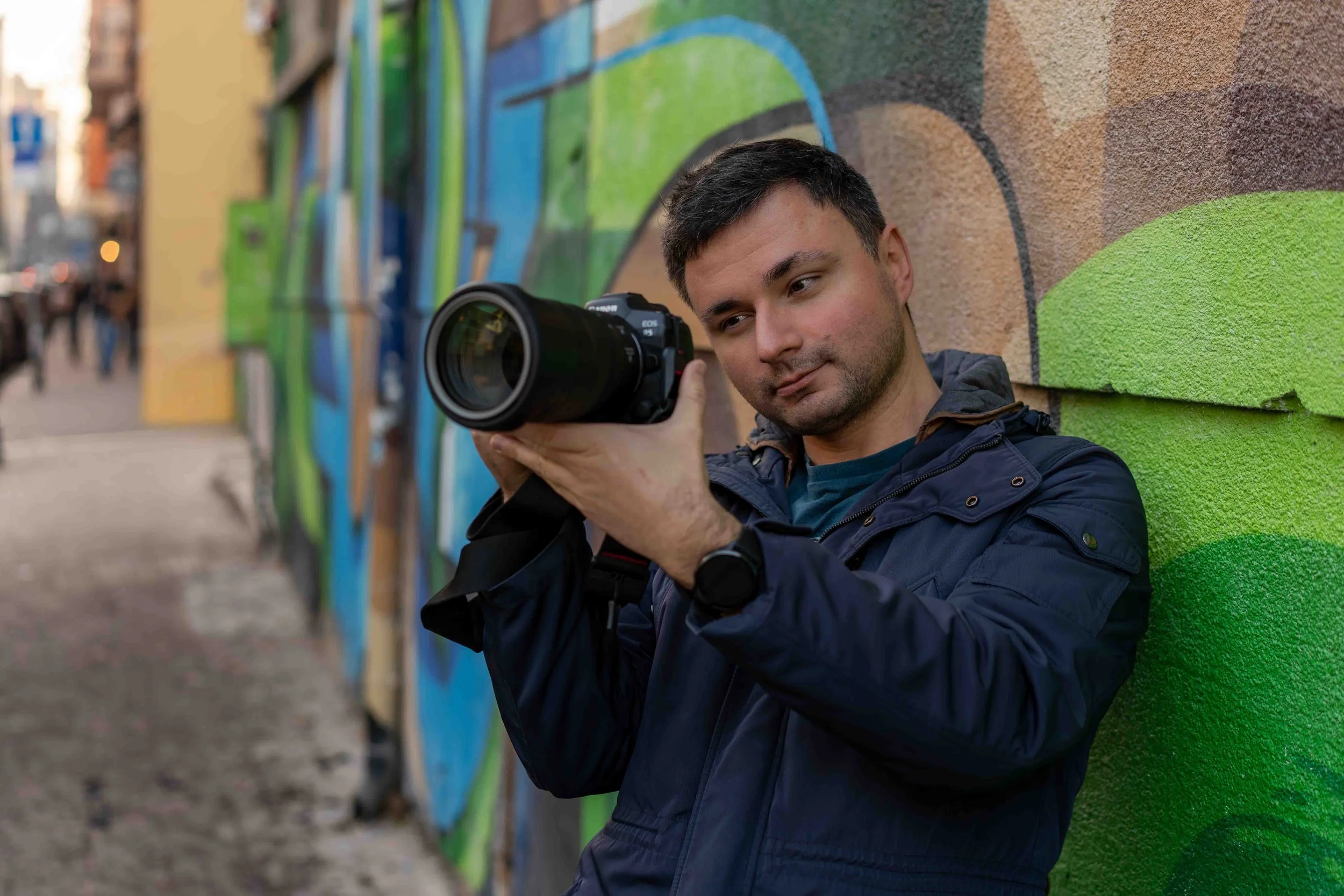 Nikolay Koshnicharov, event and portrait photographer in Sofia, holding a camera.