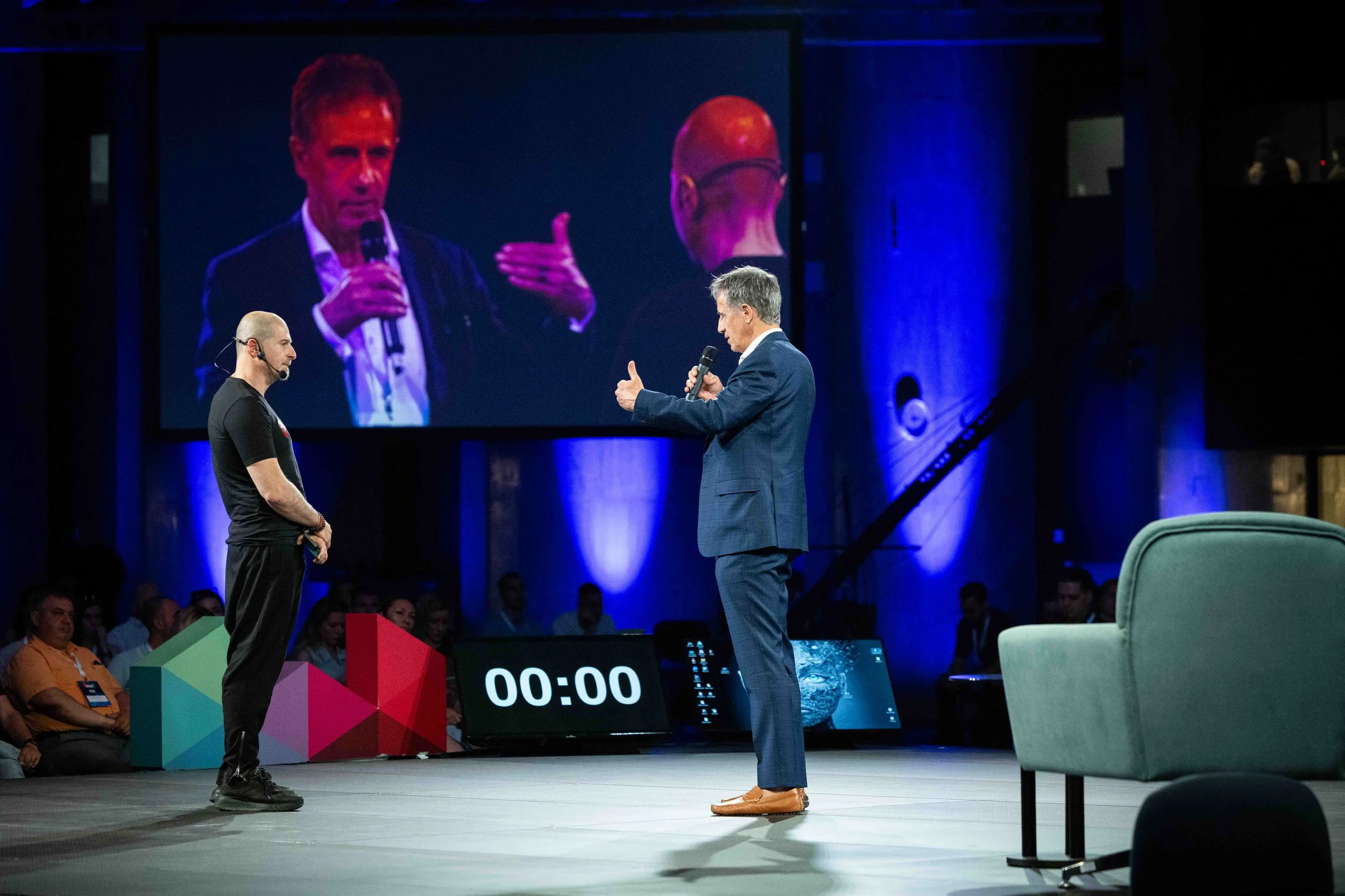 Plamen Russev, founder of Webit, speaking on stage during a live conference session.