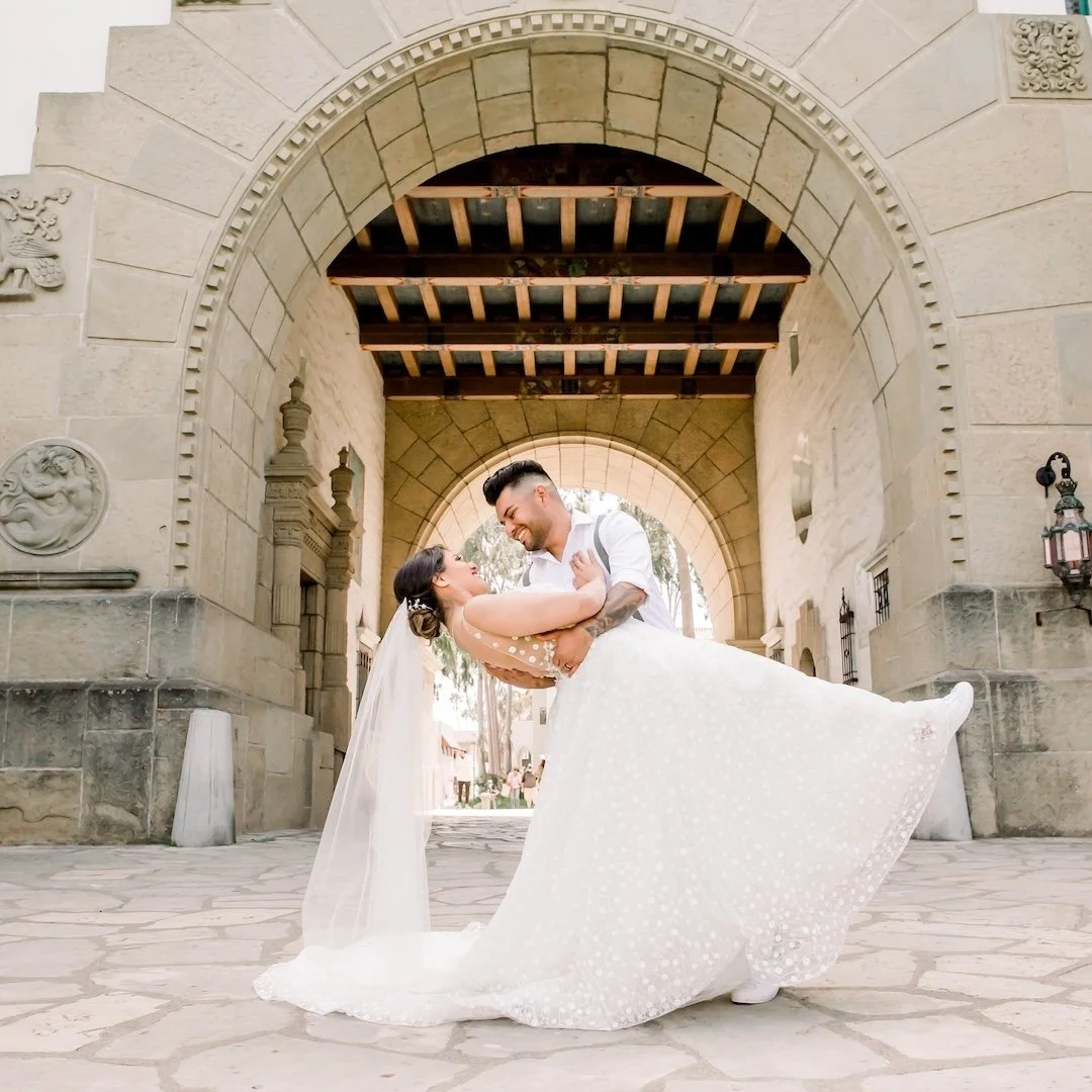 Wedding couple after Santa Barbara courthouse elopement dipping in archway